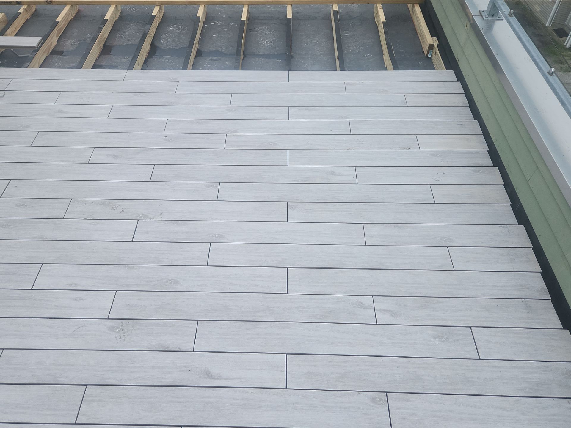 Deck Installation using Tanzite Stone Decking by A Plus Exterior