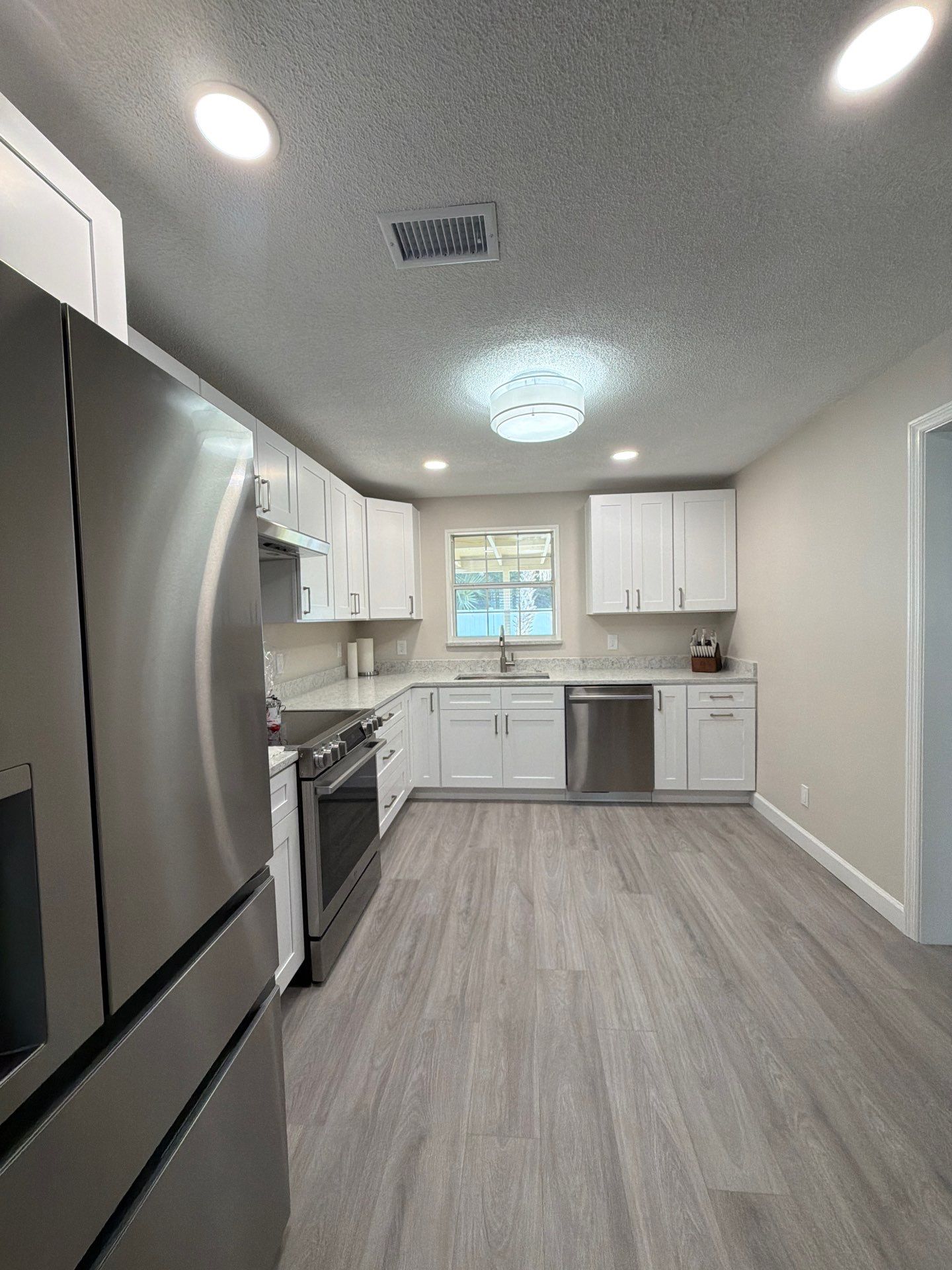 Comprehensive Home Remodel featuring Bright Modern Kitchen by Acies Renovations