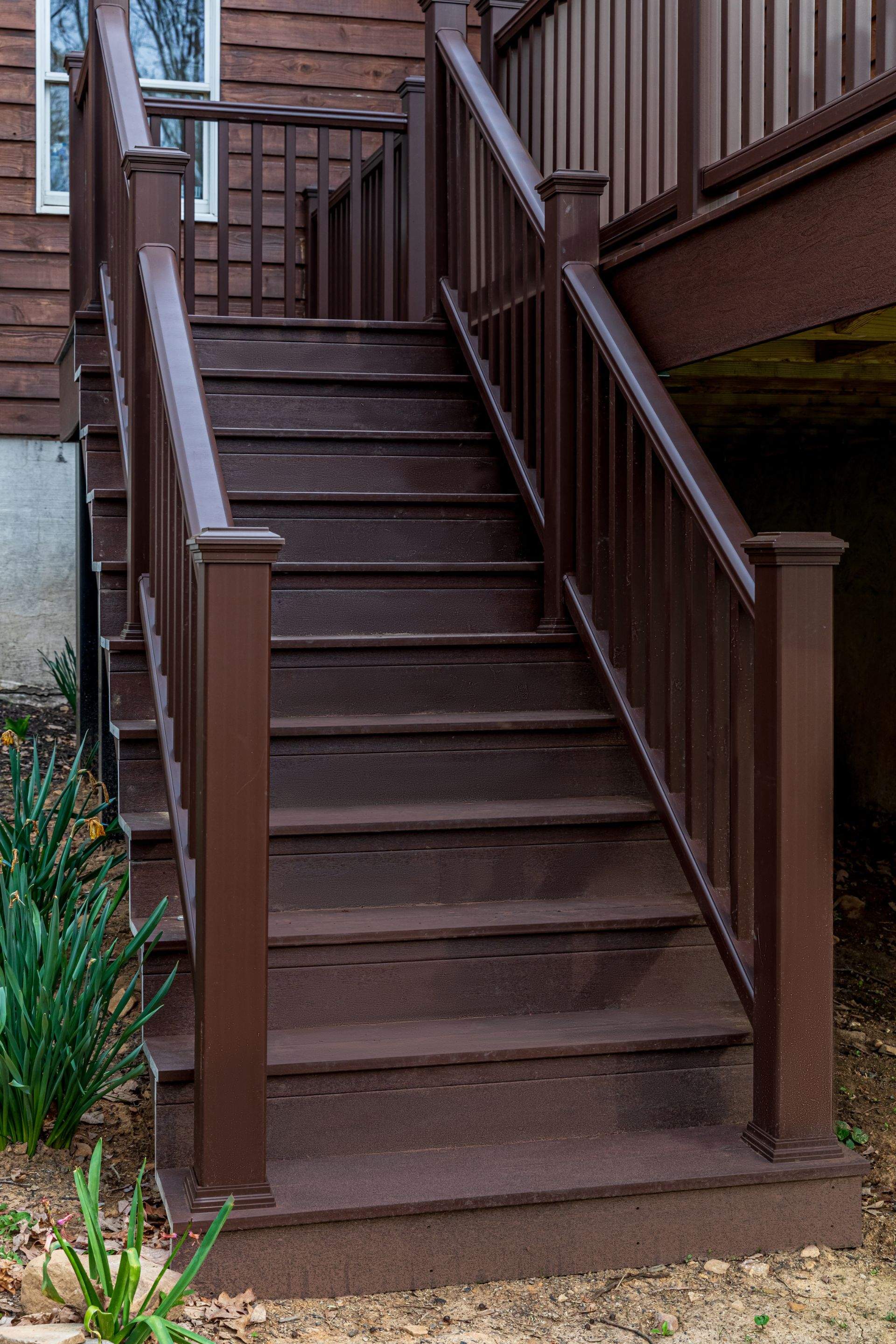 Metal Roof-barn red and new deck by Esh Builders