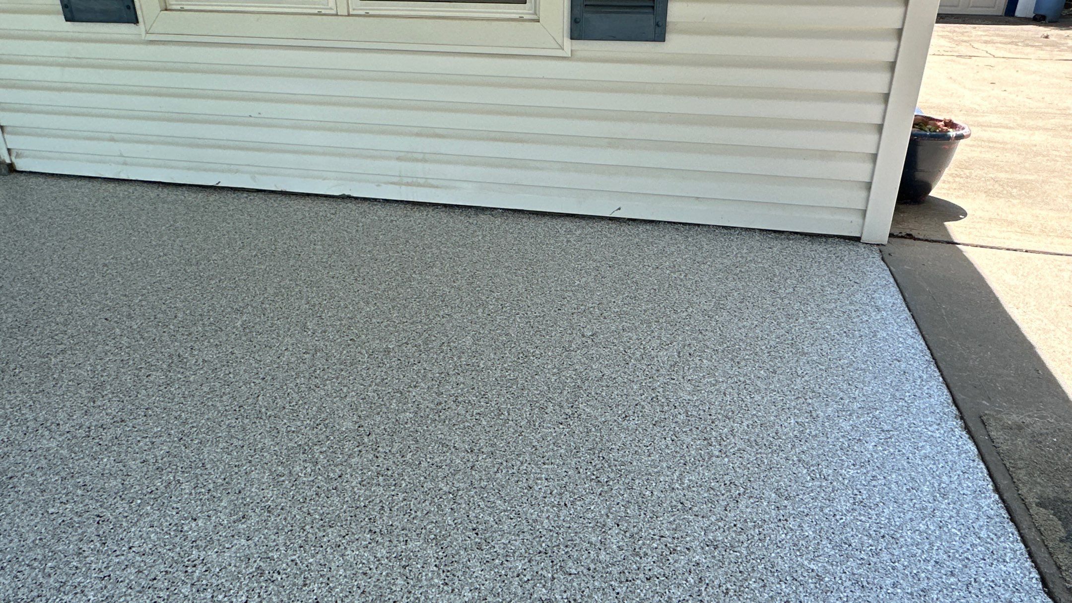 Look at this beautiful Coyote flake floor on this patio by Banner Garage