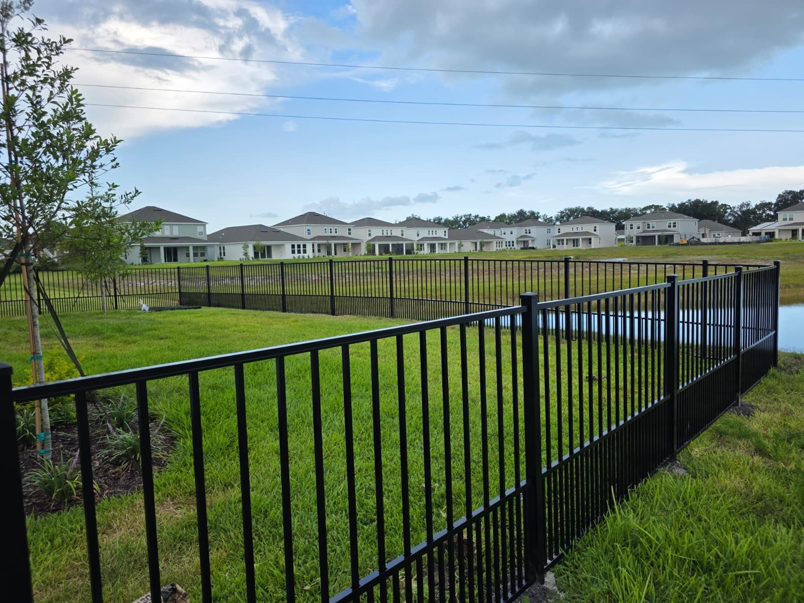 Black Aluminum Puppy Picket Fence Installation in Nokomis by True Fence LLC