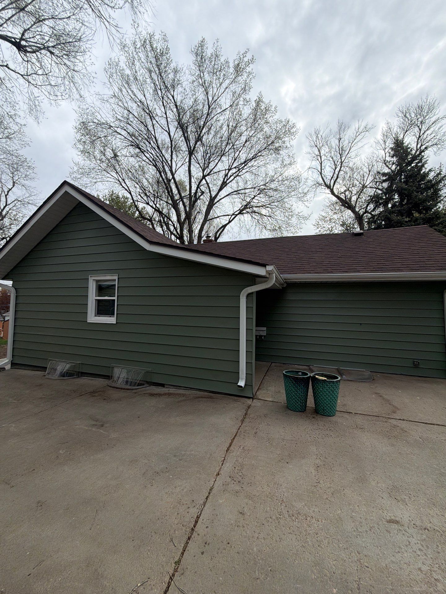 Exterior Siding Repair and Full House Repaint in Sioux Falls by Select Painting, Coatings & Garage Cabinets