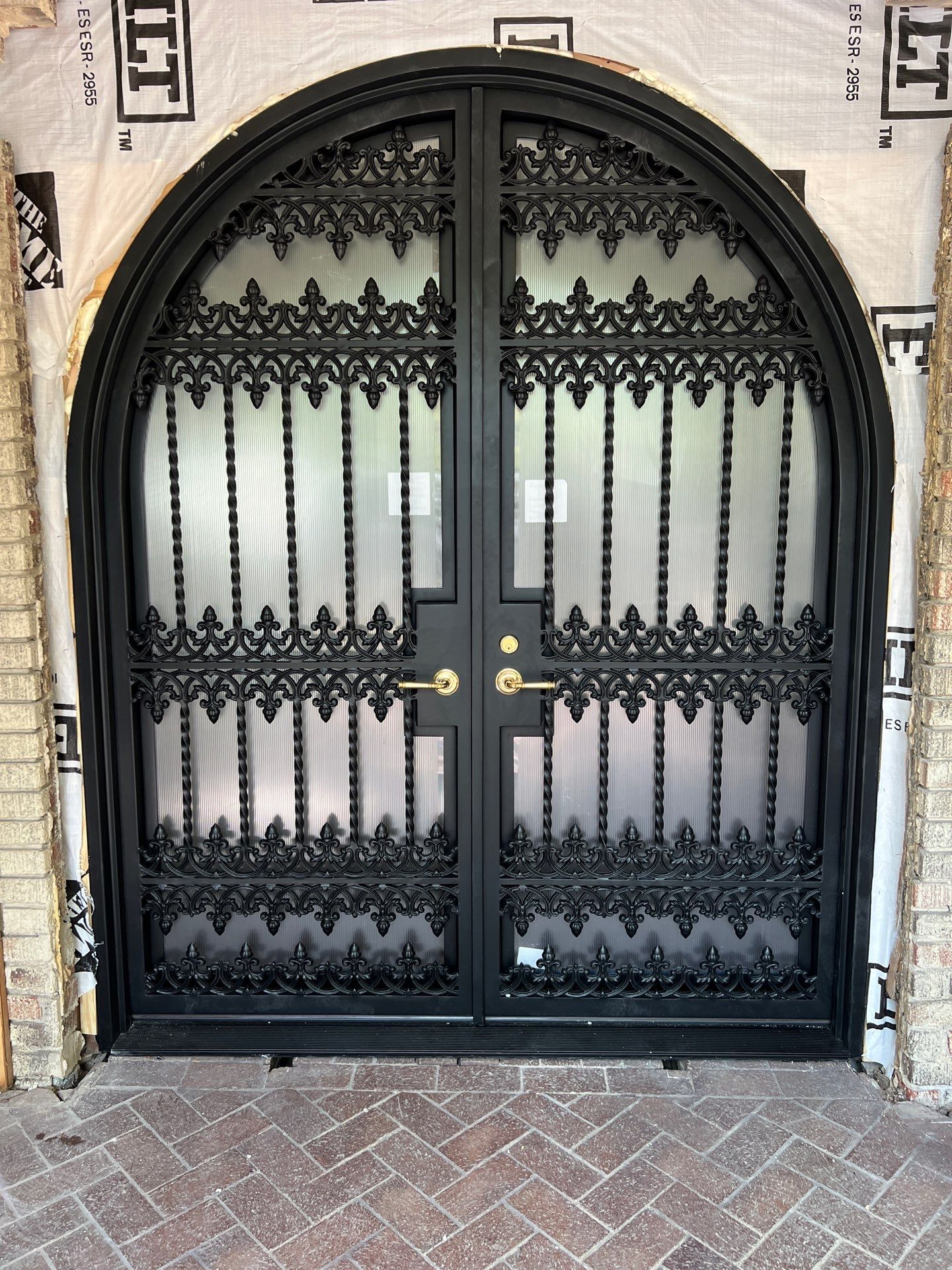 Custom Arched Black Wrought Iron Double Door Installation in Dallas by Solara Custom Living