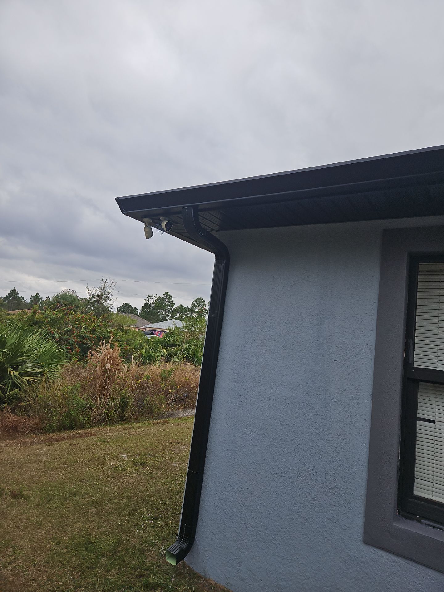 Black Seamless Gutters & Soffit/Fascia in Lehigh Acres FL by Gutter Professors