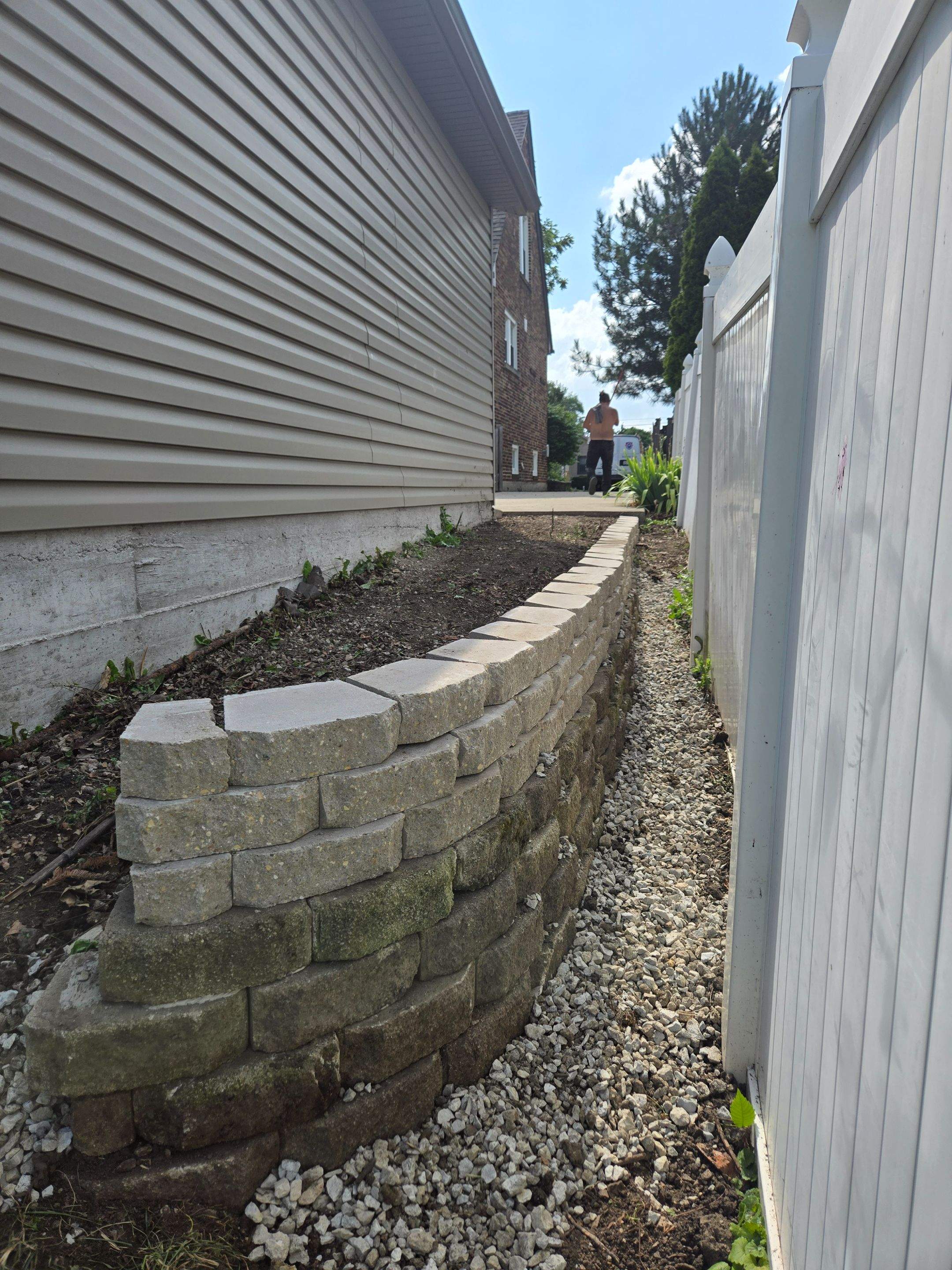Split faced landscape block retaining wall and French Drain Installation by Allied Water Services