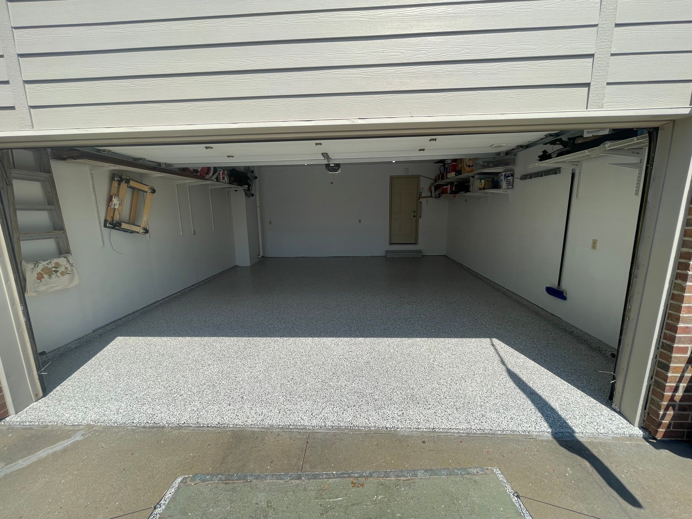 Sioux Falls Residential Garage Floor Coating with Speckled Epoxy Finish by Select Painting, Coatings & Garage Cabinets
