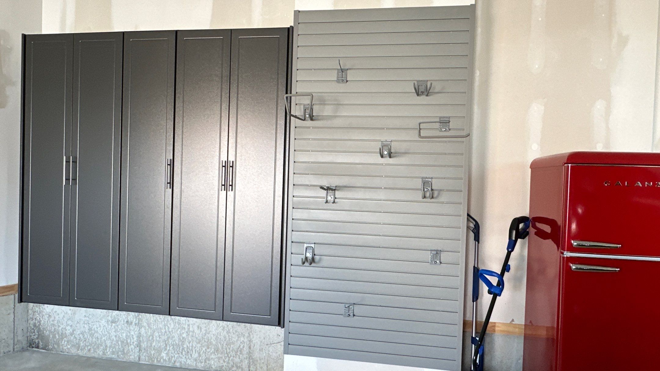 Megan J. added cabinets and slotwall to her garage. Plus a New Floor by Banner Garage