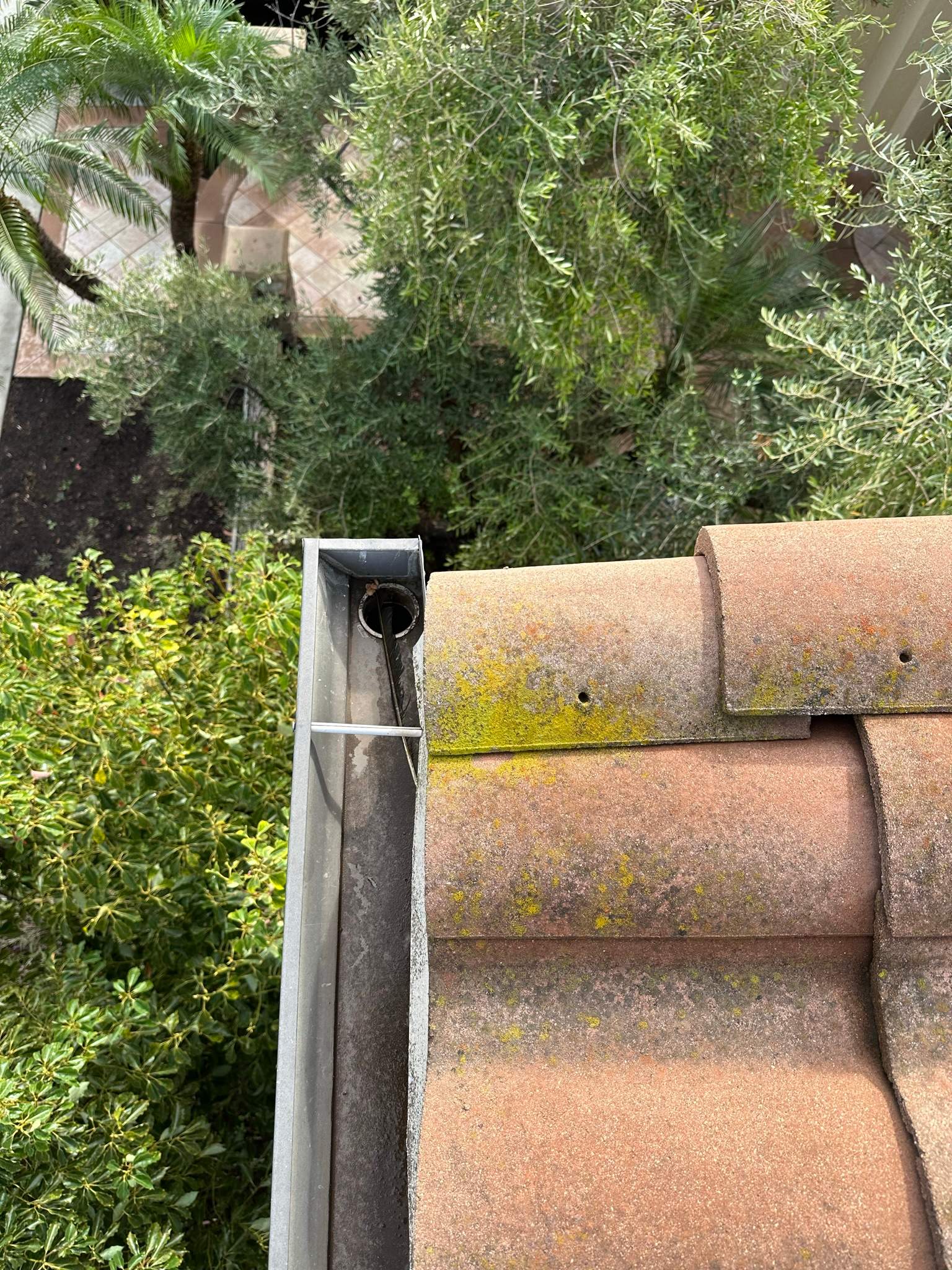 Clogged gutters at this Irvine home in Woodbury by Property Cleaning Experts, LLC