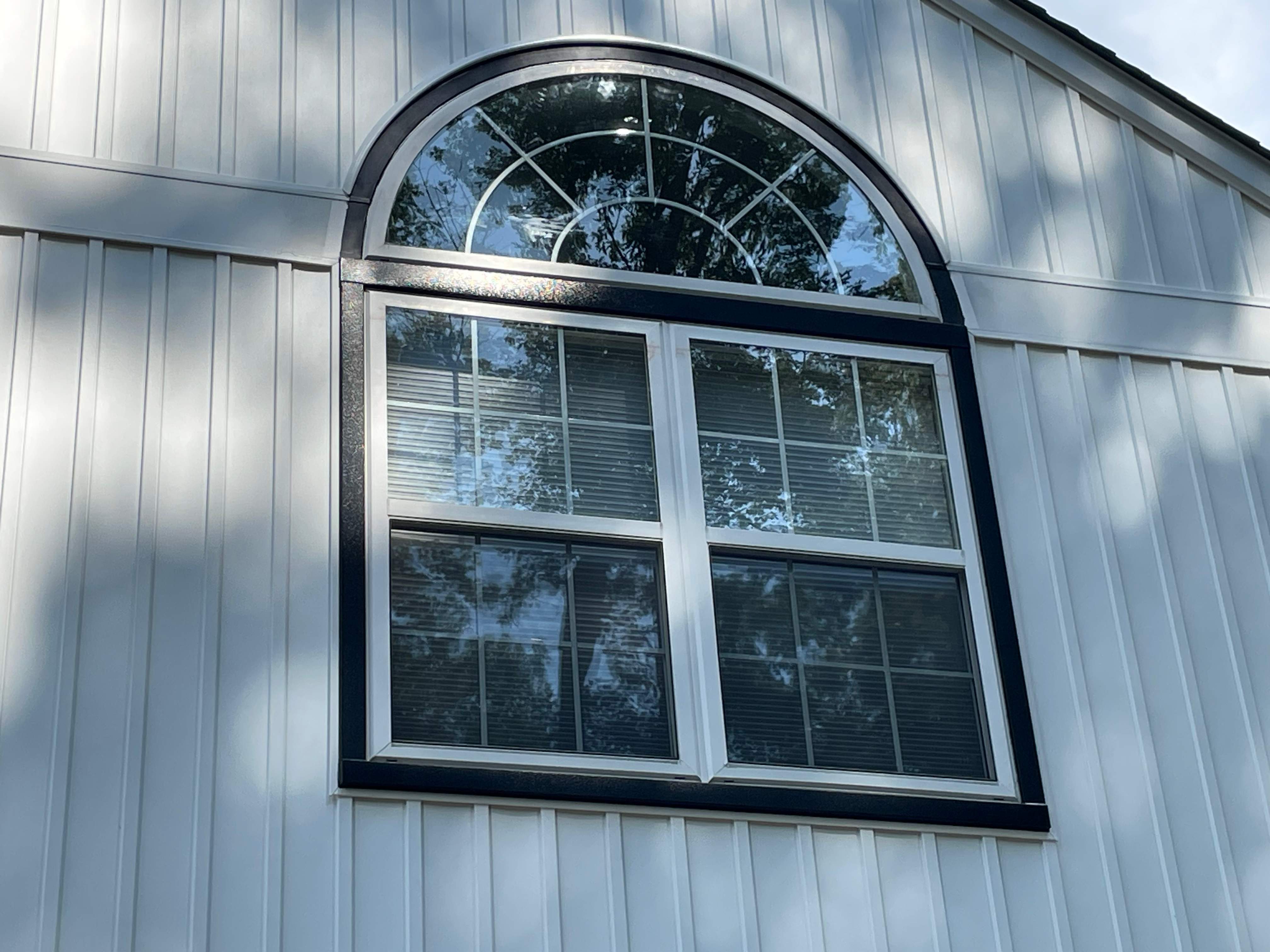 Vinyl Siding Replacement + Black Trim by American Home Contractors