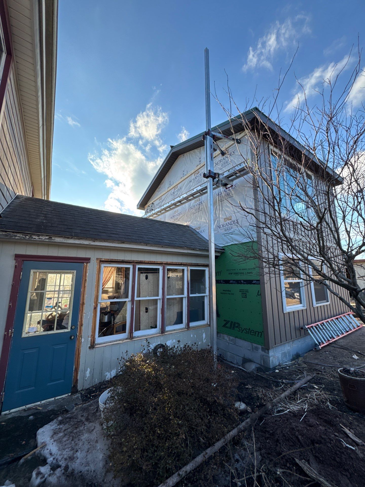 Multi-Story Residential Addition Featuring Textured Metal Siding in Millersburg by Esh Builders