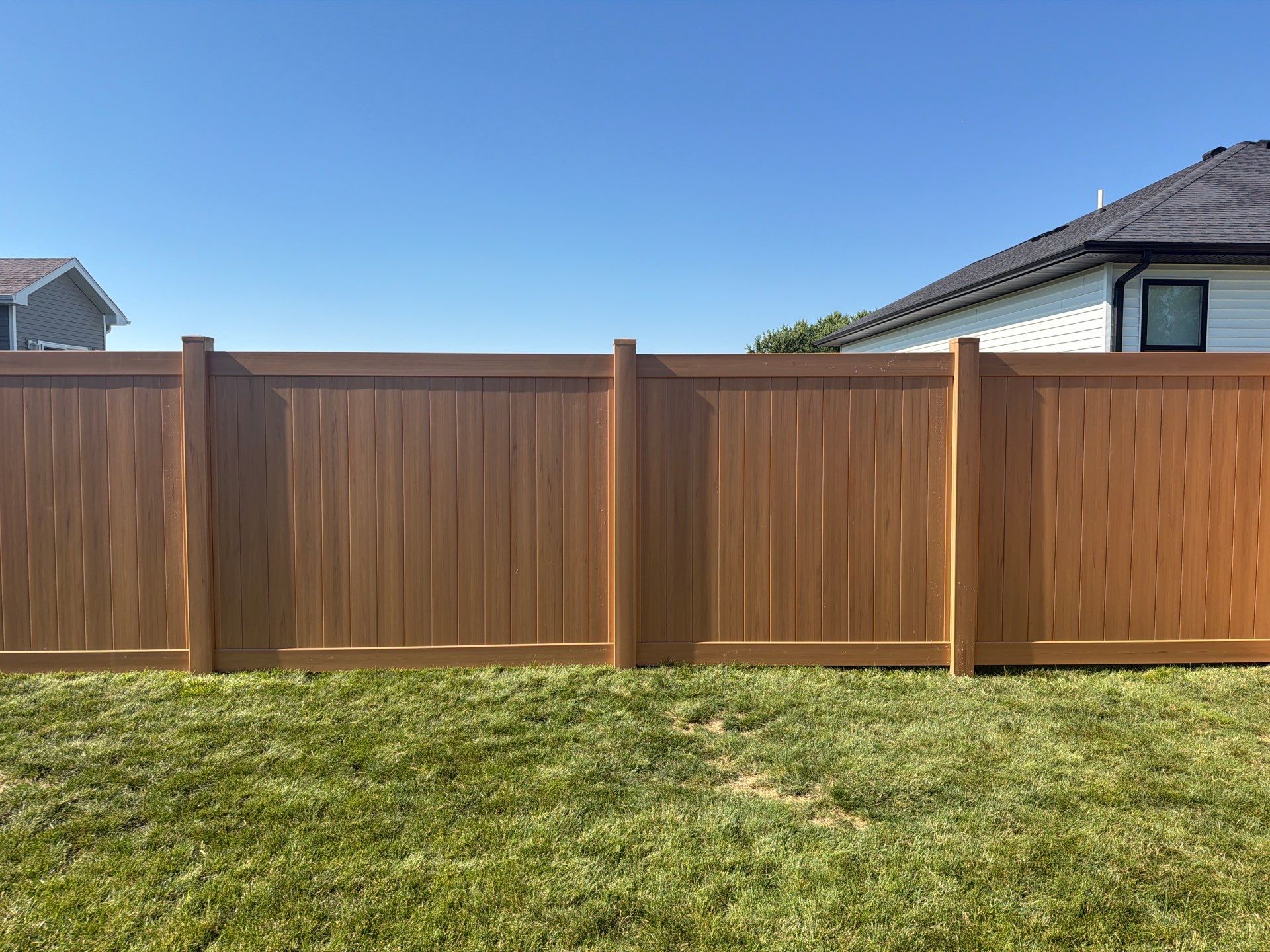 Residential Cypress Vinyl Privacy Fence Installation in Cedar Falls by Perfect Picket Fence and Stain