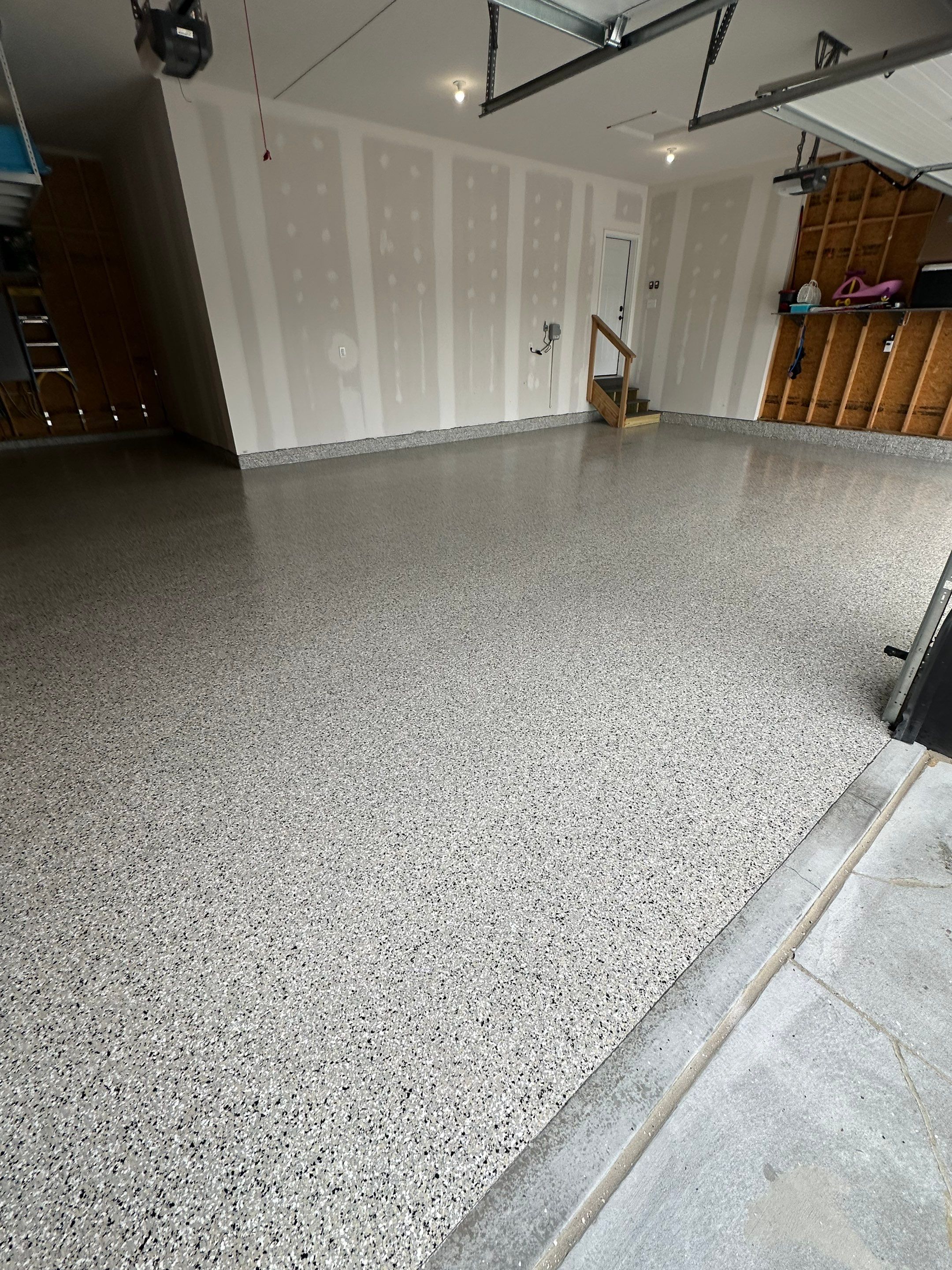 Three-Stall Garage Epoxy Floor Coating Installation in Lincoln by Goat Coatings