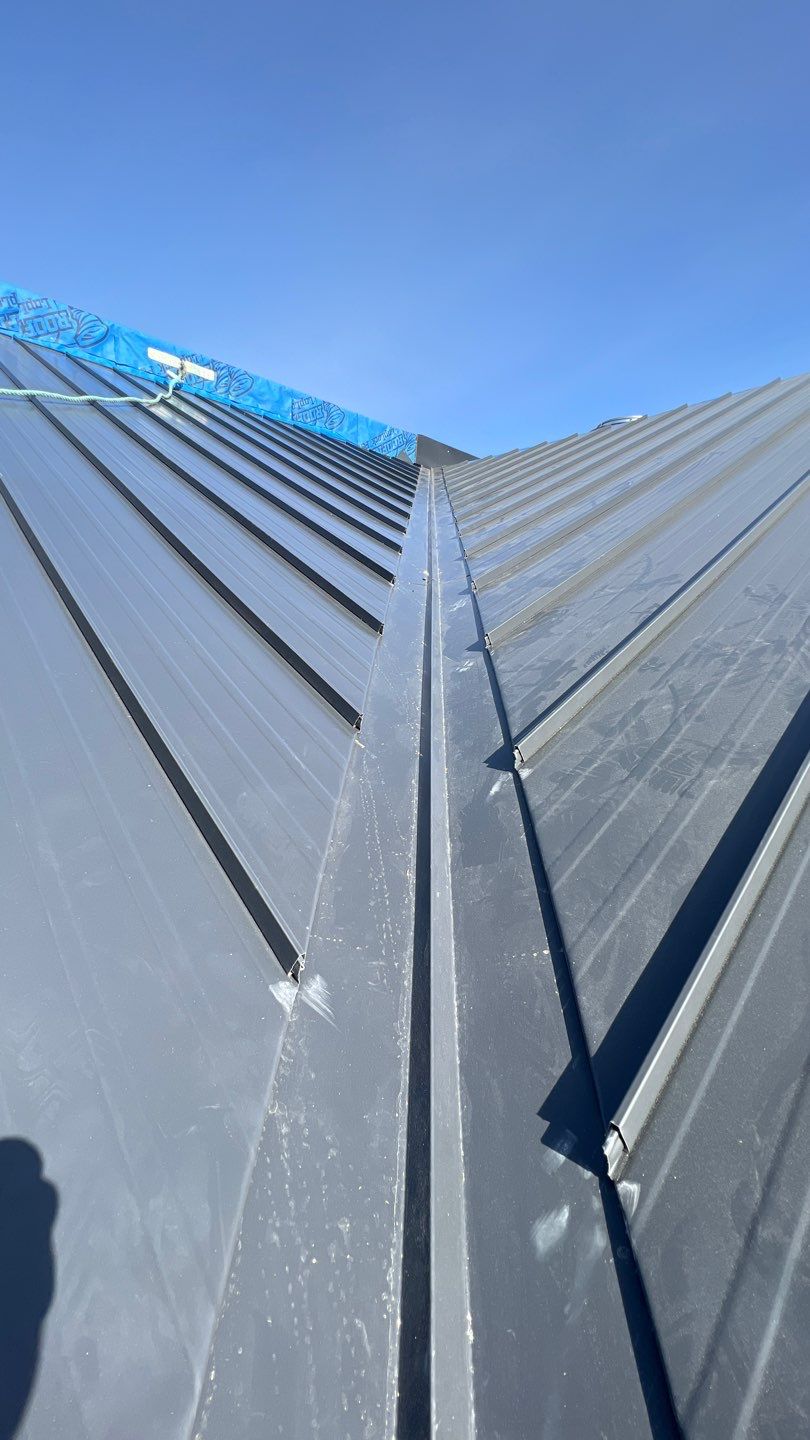 Commercial Roofing Installation using 12" Prolok metal and hidden gutters! by Top Notch Roofing Inc