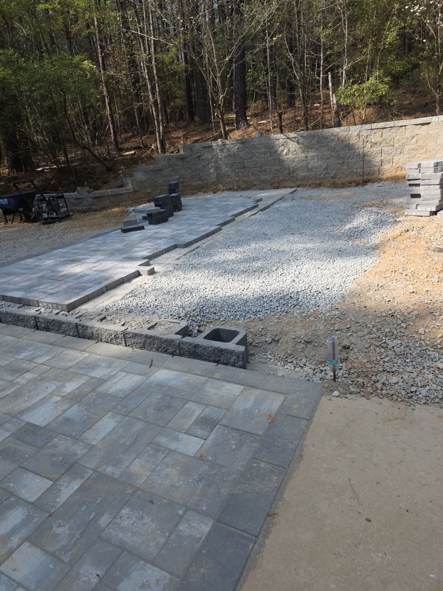 Pittsboro Outdoor Living Transformation – Retaining Wall, Paver Patio & Elevated Deck by Elite Remodeling and Design LLC