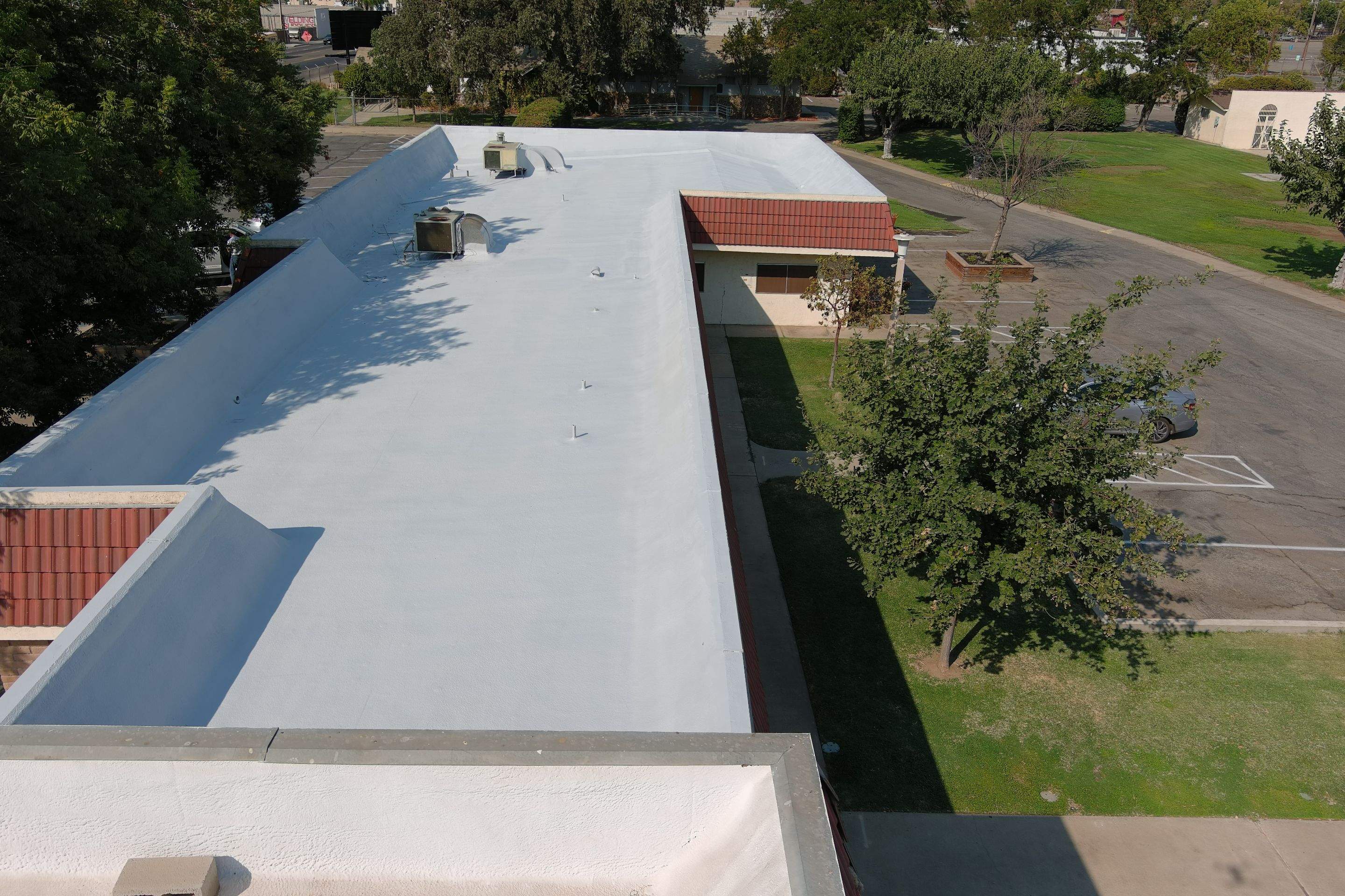 Commercial Roofing Installation using General Coatings acrylic coatings and spray foam by Straight Edge Roofing Inc