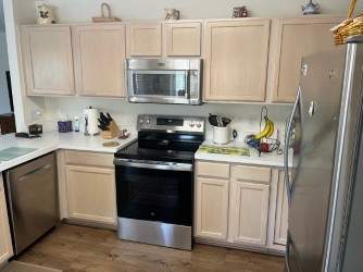 White Shaker Cabinet Installation and Quartz Countertop Replacement in Rochester by Top Shelf Painter