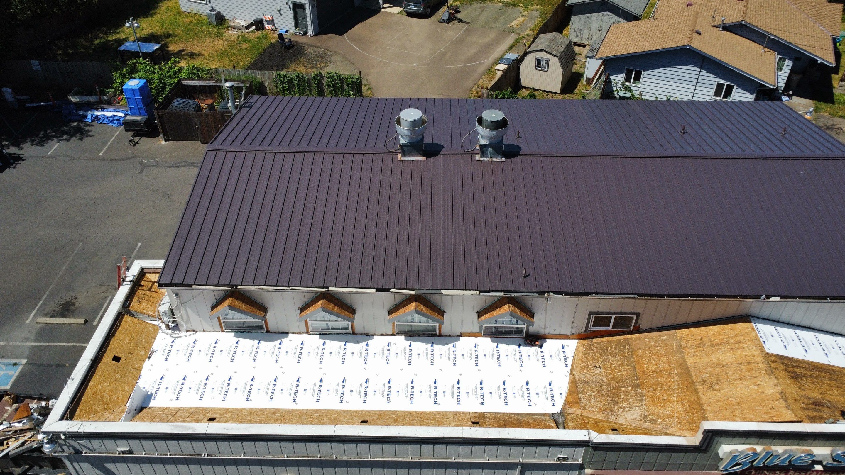 Commercial Flat Roof Installation using Bruce and Dana Snap Lock Metal (Color: Brown) by Orezona Building & Roofing Company, Inc.
