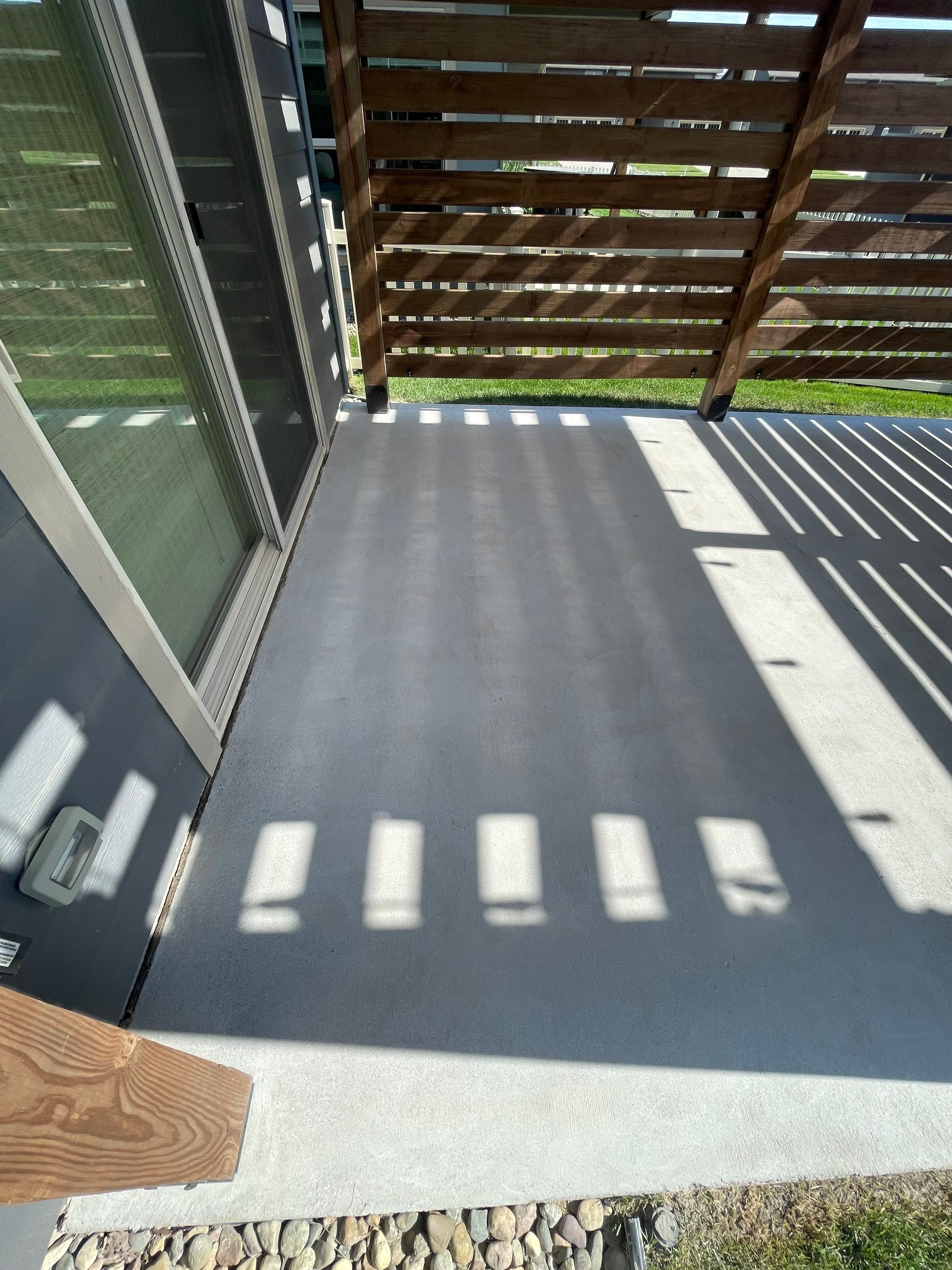 Textured Concrete Patio Coating and Custom Privacy Pergola in Sioux Falls by Select Painting, Coatings & Garage Cabinets