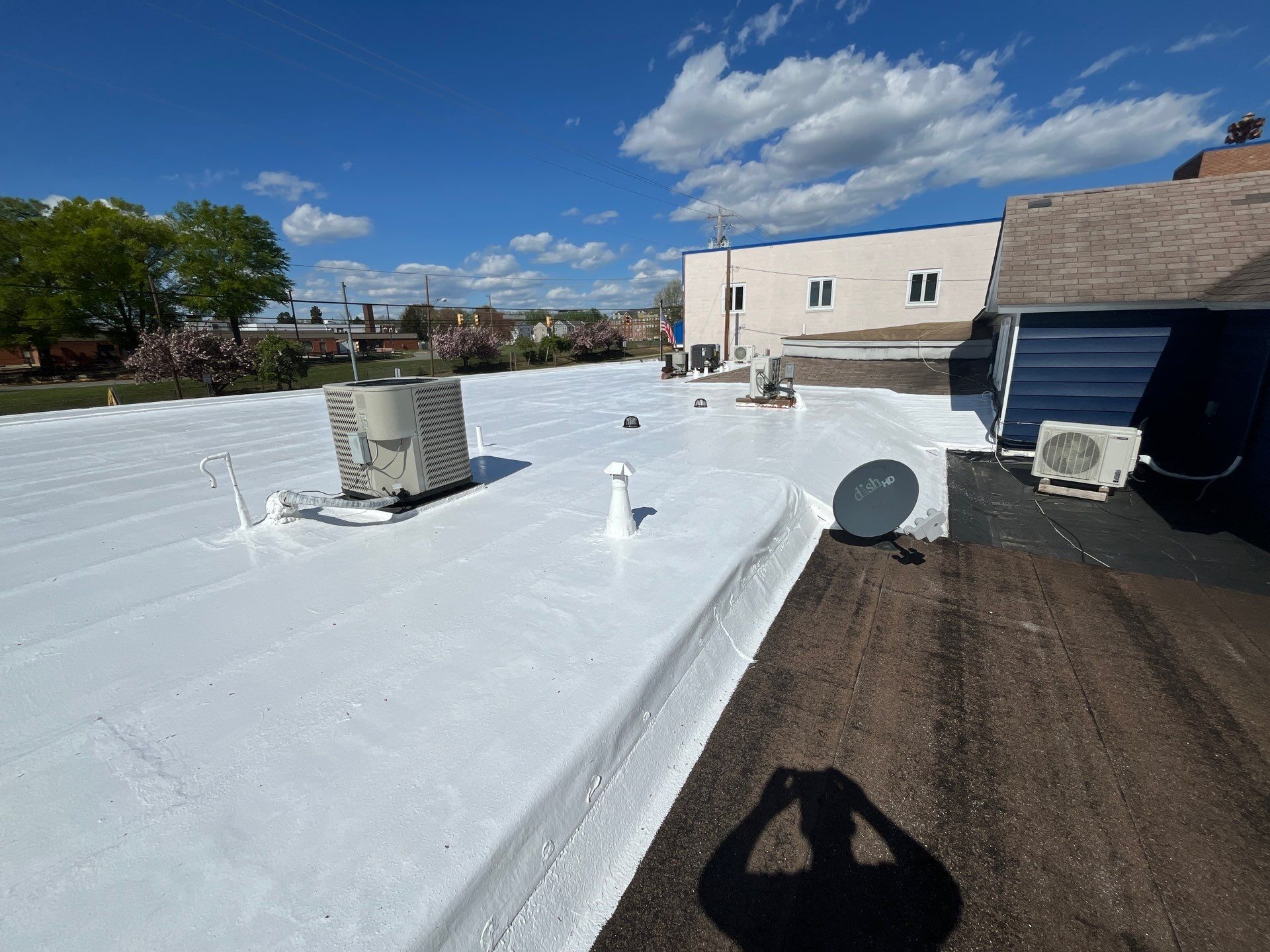Roof Installation using Silicone Modified Flat Roof Coating by ExteriorPros