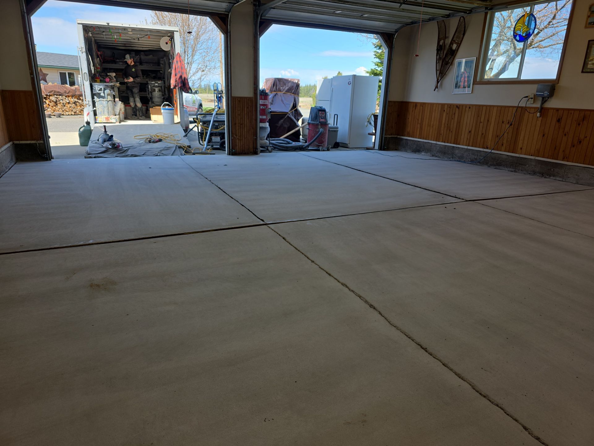 Sandstone Polyaspartic Garage Floor Coating Transformation in Davenport by Croc Coatings, LLC