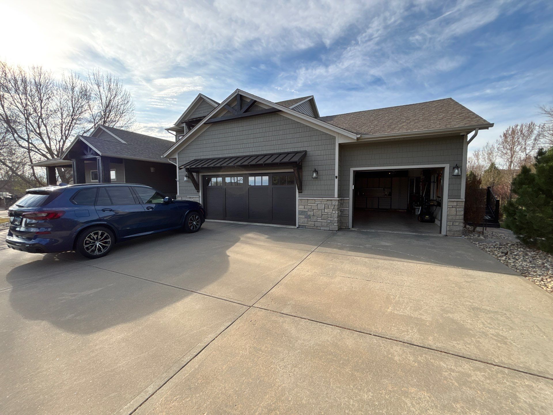 Exterior Wood Staining and Epoxy Garage Floor Coating in Brandon by Select Painting, Coatings & Garage Cabinets