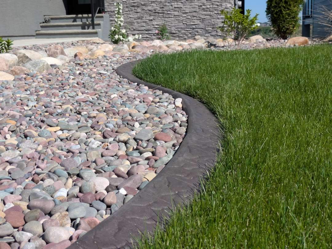 Decorative Concrete Curbing and River Rock Landscape Installation