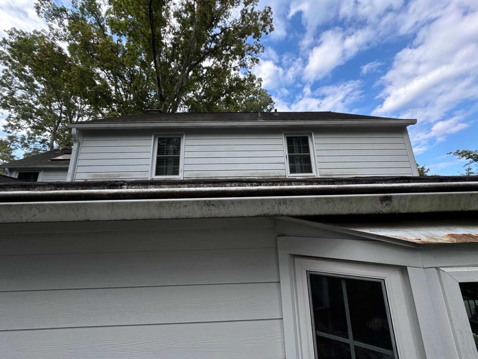 house siding and gutters being pressure washed to remove dirt and mold in winston salem nc