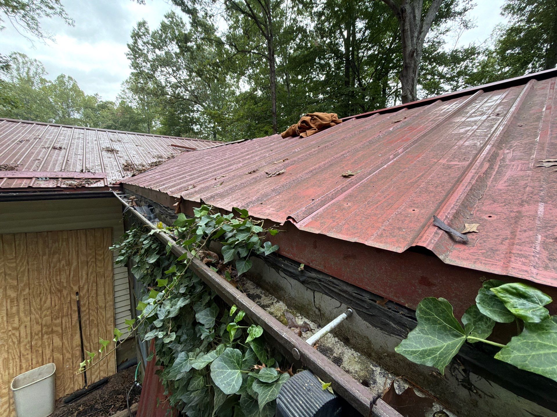 Red Metal Roof Restoration and Wood Fascia Replacement in Barboursville by Cade Construction