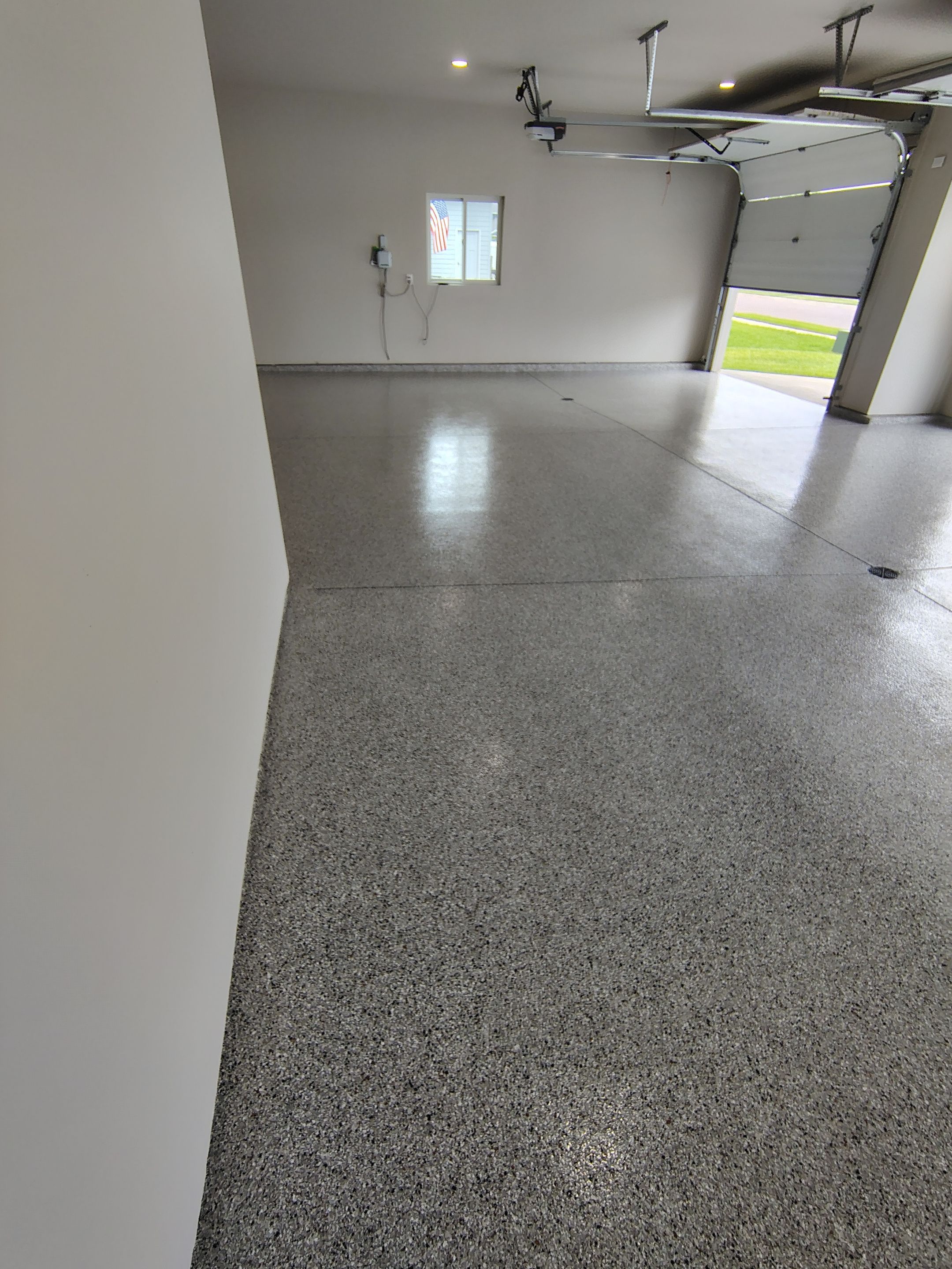 Grey Speckled Epoxy Garage Floor Coating in Sioux Falls by Select Painting, Coatings & Garage Cabinets