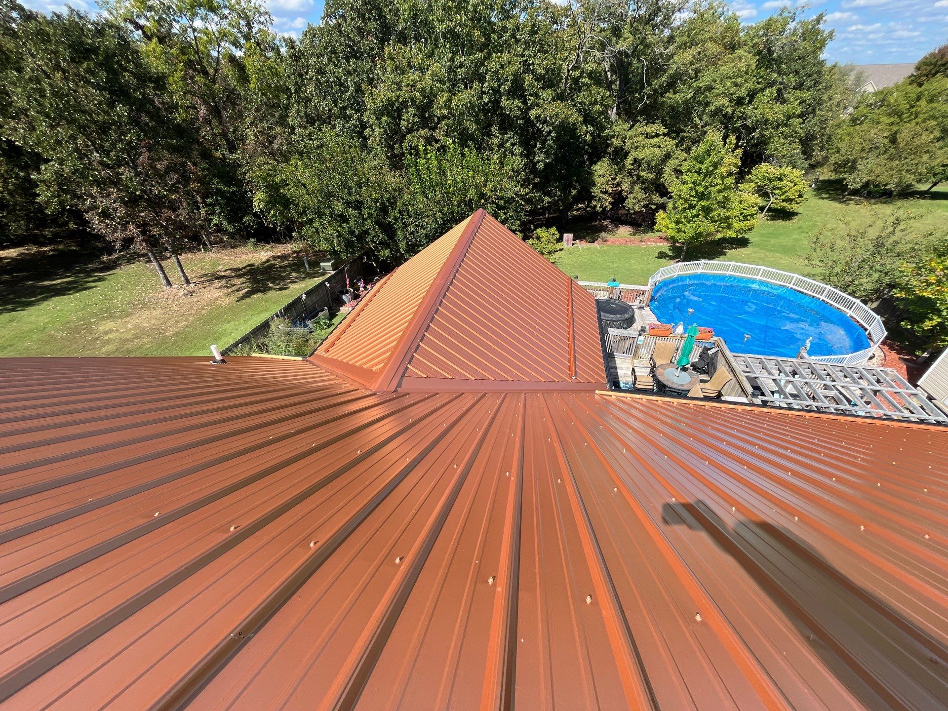 Residential Roofing Install - Copper 29 Guage G-Rib Metal & 6" Inch Seamless Gutters + 3"x4" Aluminum Downspouts  by Titan Commercial & Residential Roofing 