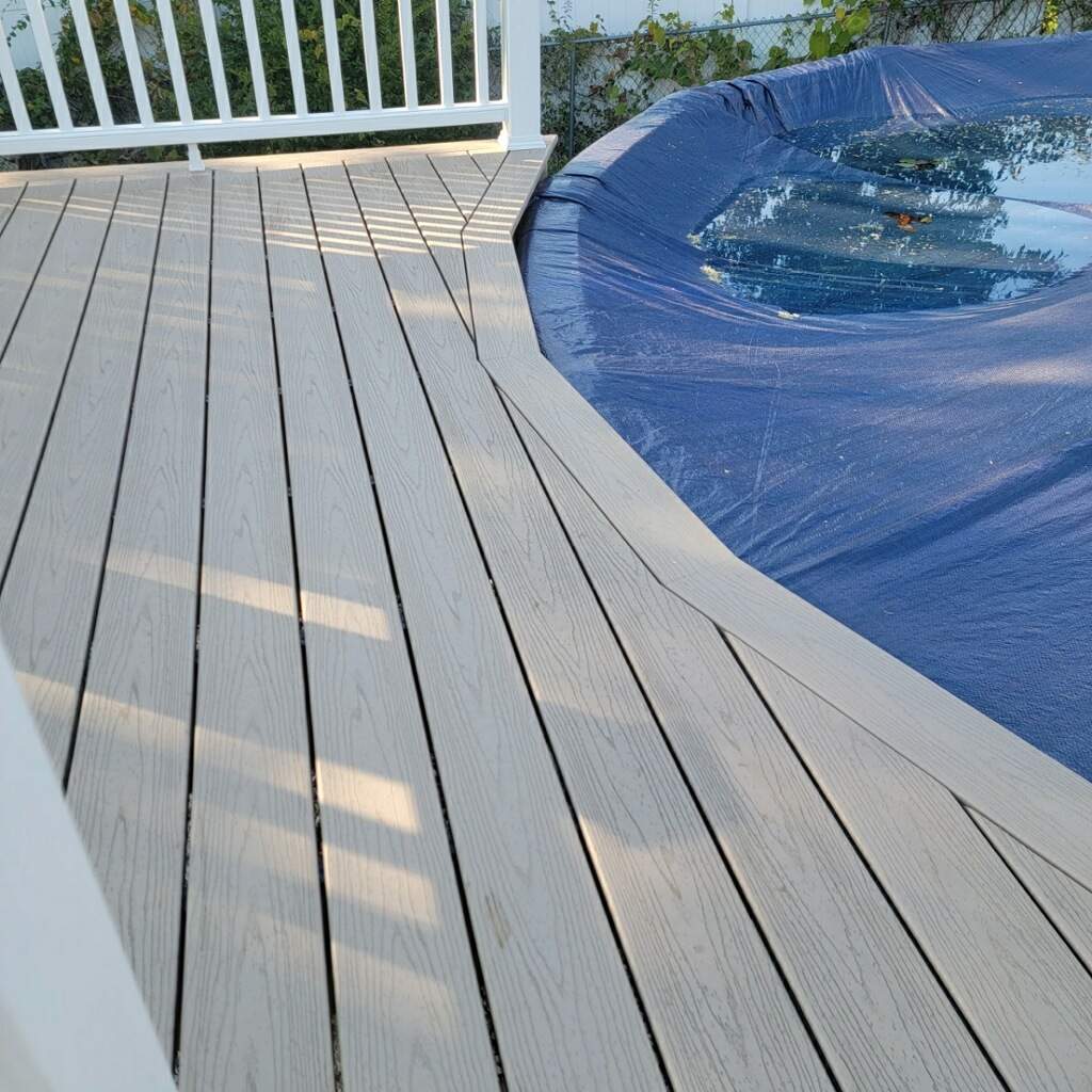 New pool deck and main deck resurface using Trex Transcend Rope Swing boards, White railing and Lattice by DiGiorgi Roofing and Siding Inc