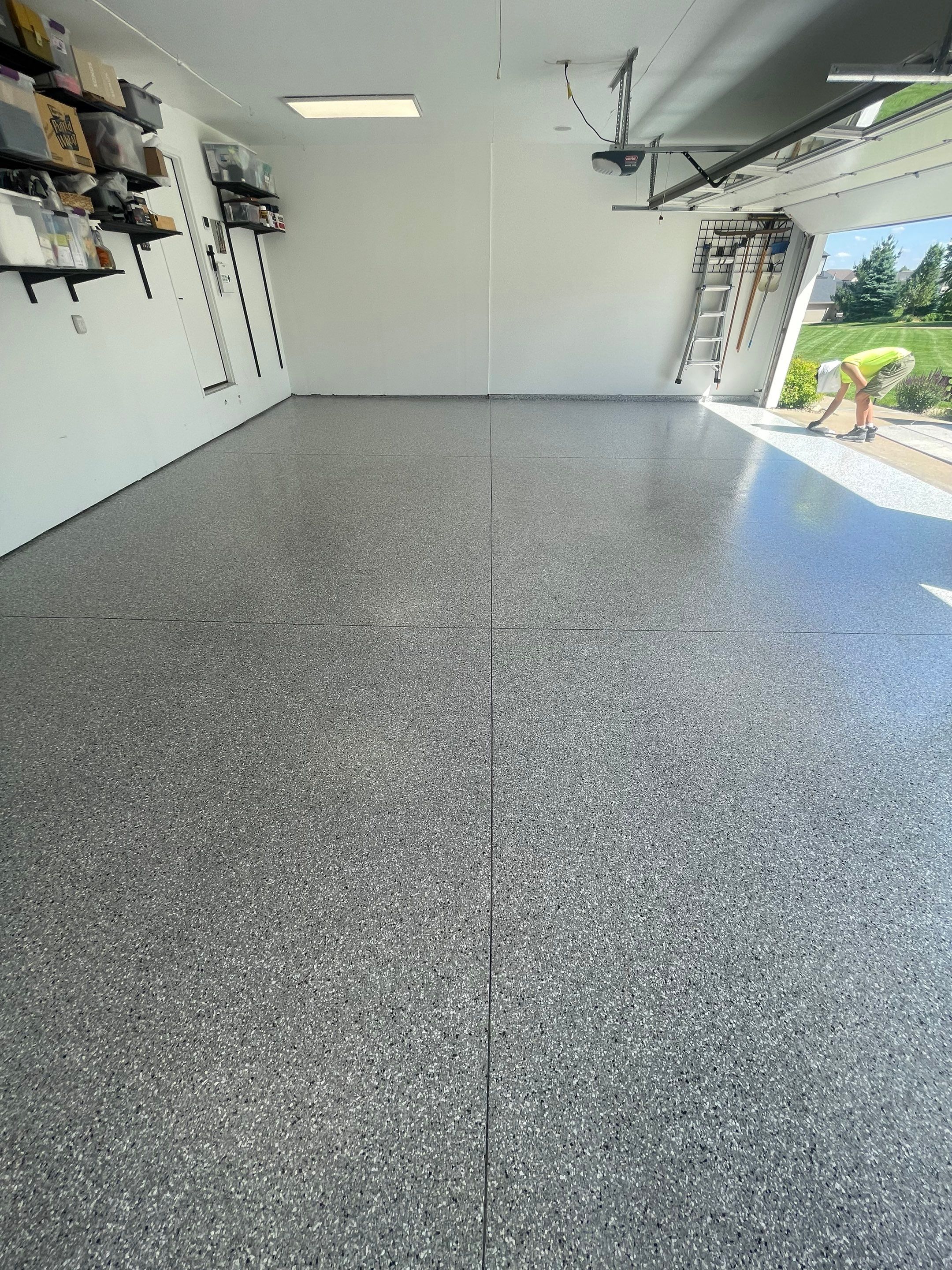 Feather Grey Garage Floor Coating Installation in Sioux Falls by Select Painting, Coatings & Garage Cabinets
