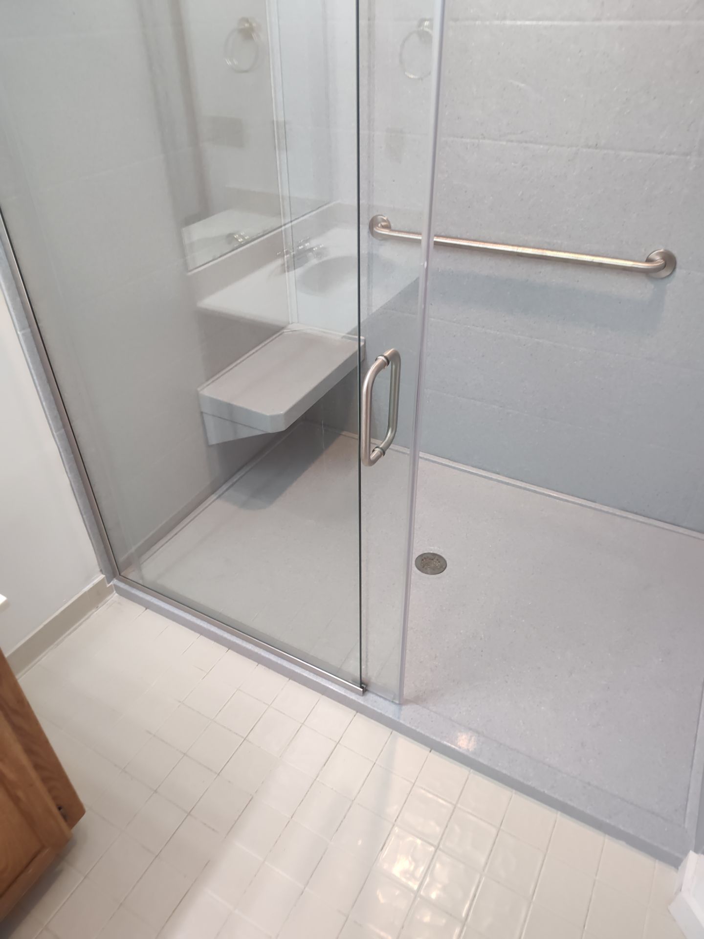 Bathroom Remodel using Onyx base and shower walls with seat & caddie by Cornerstone Home Builders, LLC