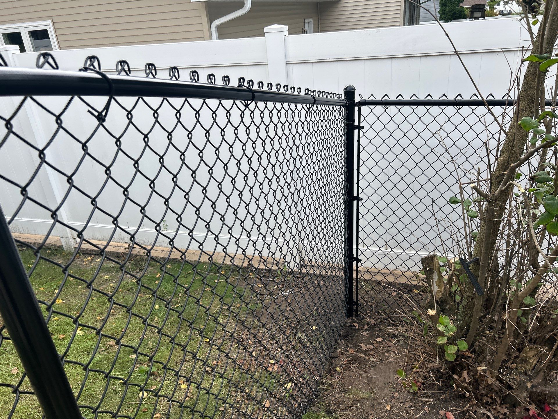 Black Vinyl Coated Chain Link Fence Installation in Waterloo by Perfect Picket Fence and Stain