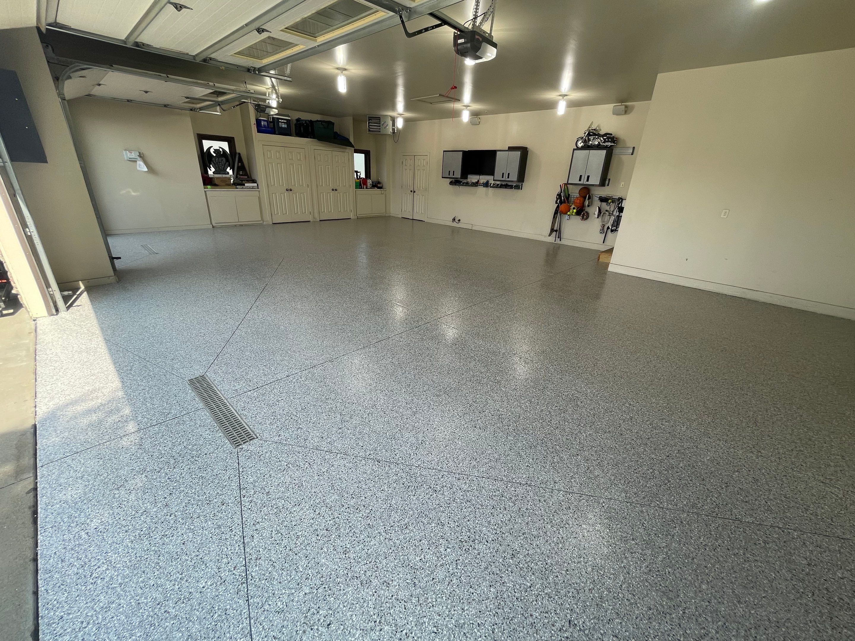 Coyote Flake Garage Floor Coating in Sioux Falls with Trench Drain by Select Painting, Coatings & Garage Cabinets