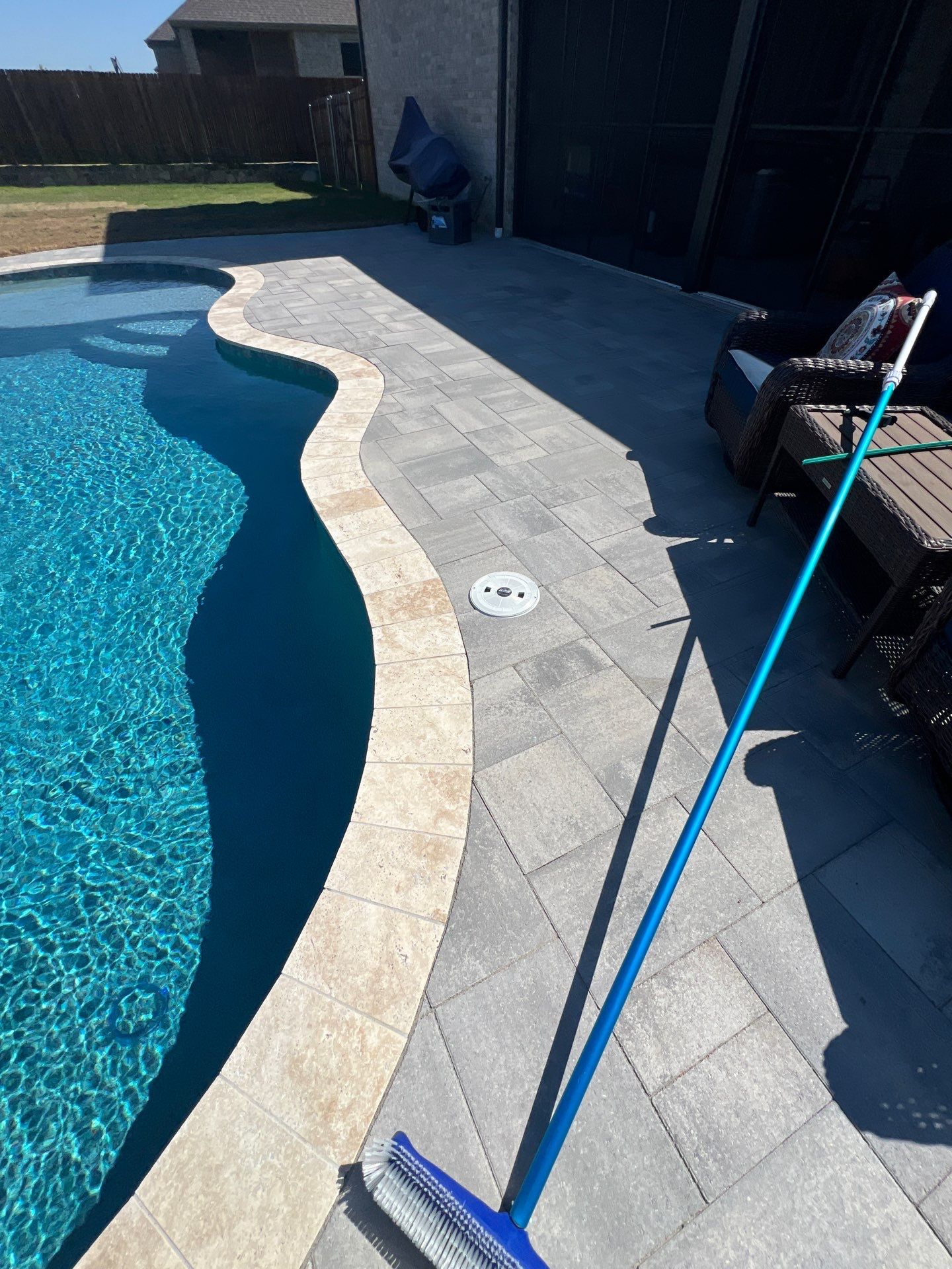 Freeform Pool with Raised Stone Accent Wall by Pinnacle Pools and Spas - DFW