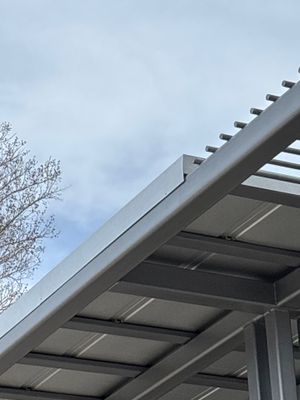 Completed metal roof structure against blue sky