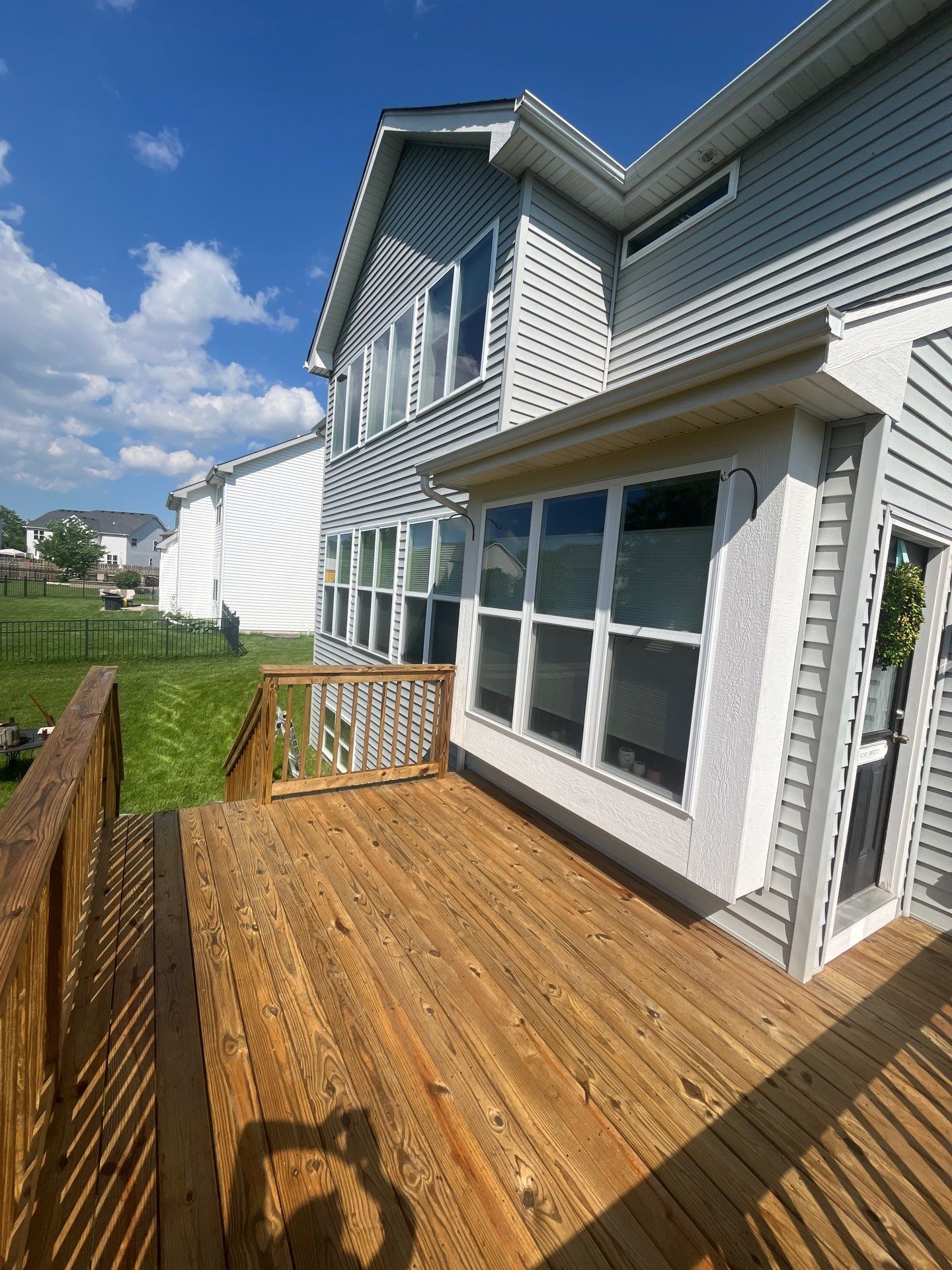 wood deck cleaning and staining by Northern Power Washing LLC.