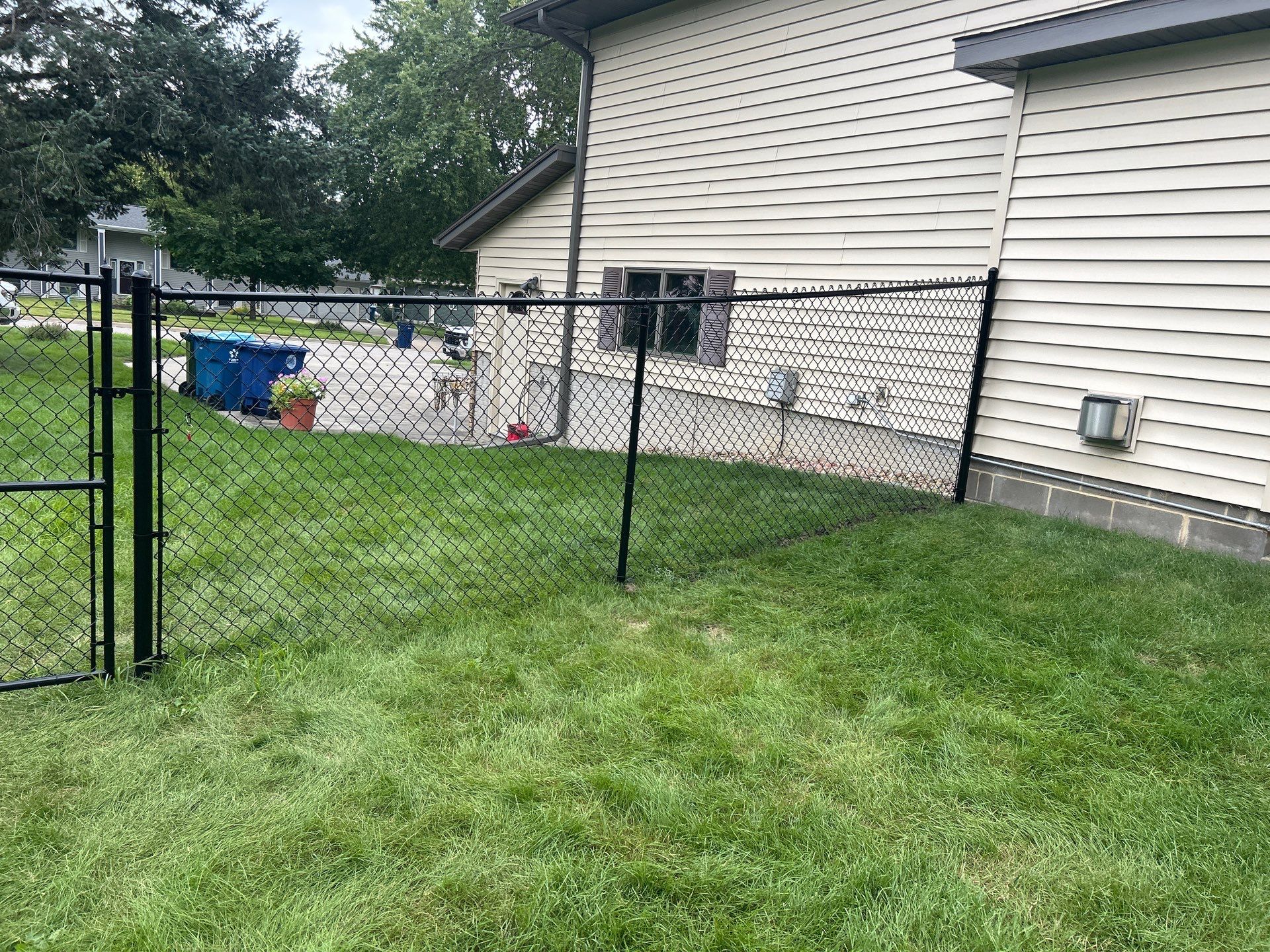 Black Vinyl Coated Chain Link Fence Installation in Waterloo by Perfect Picket Fence and Stain