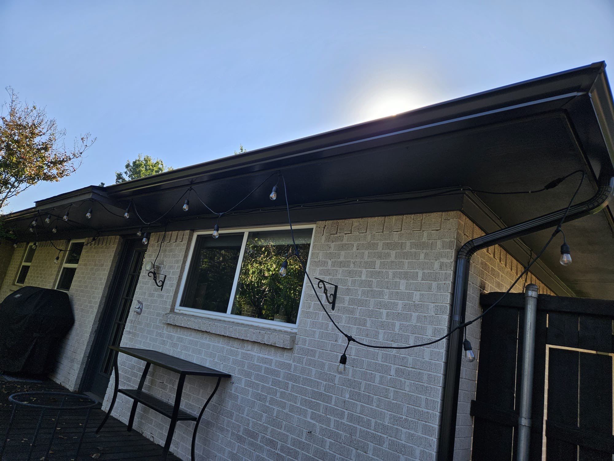 White brick/black accents with IKO Granite Black by Tejas Roofworks + Restoration
