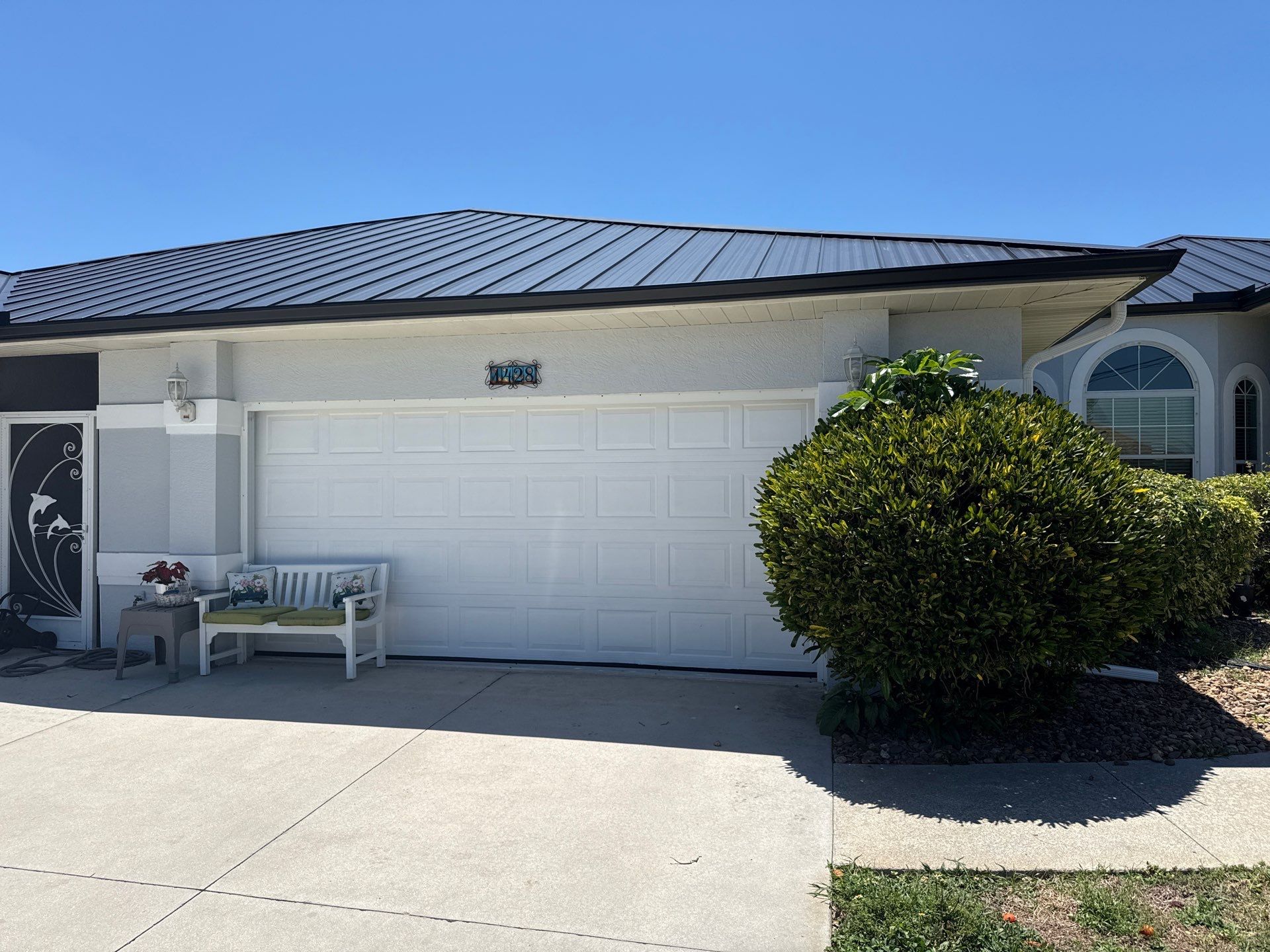 Black Seamless Gutters and White Downspouts in Cape Coral FL by Gutter Professors