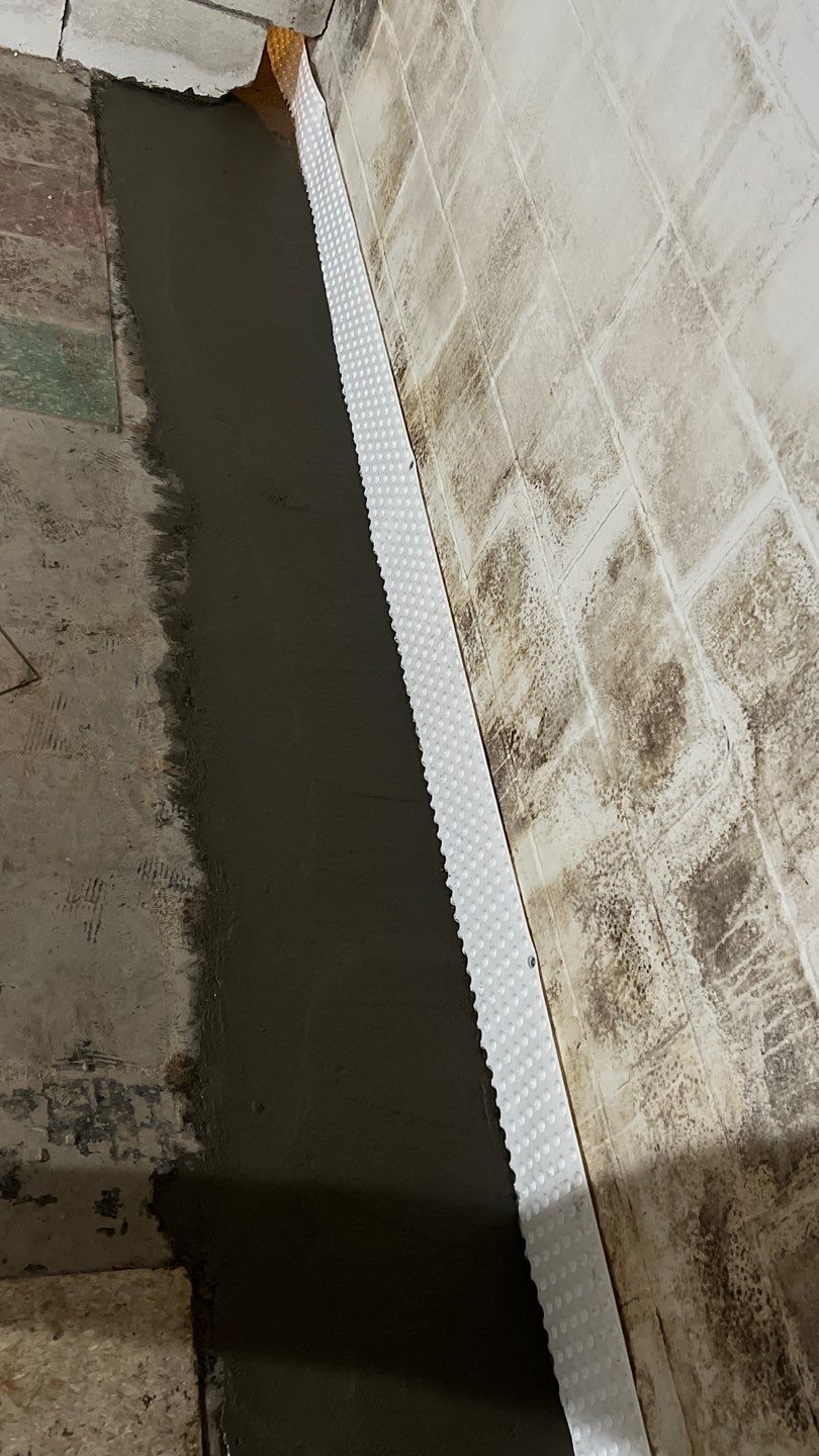 Interior drain tile system installation by ACE Waterproofing & Basement Solutions