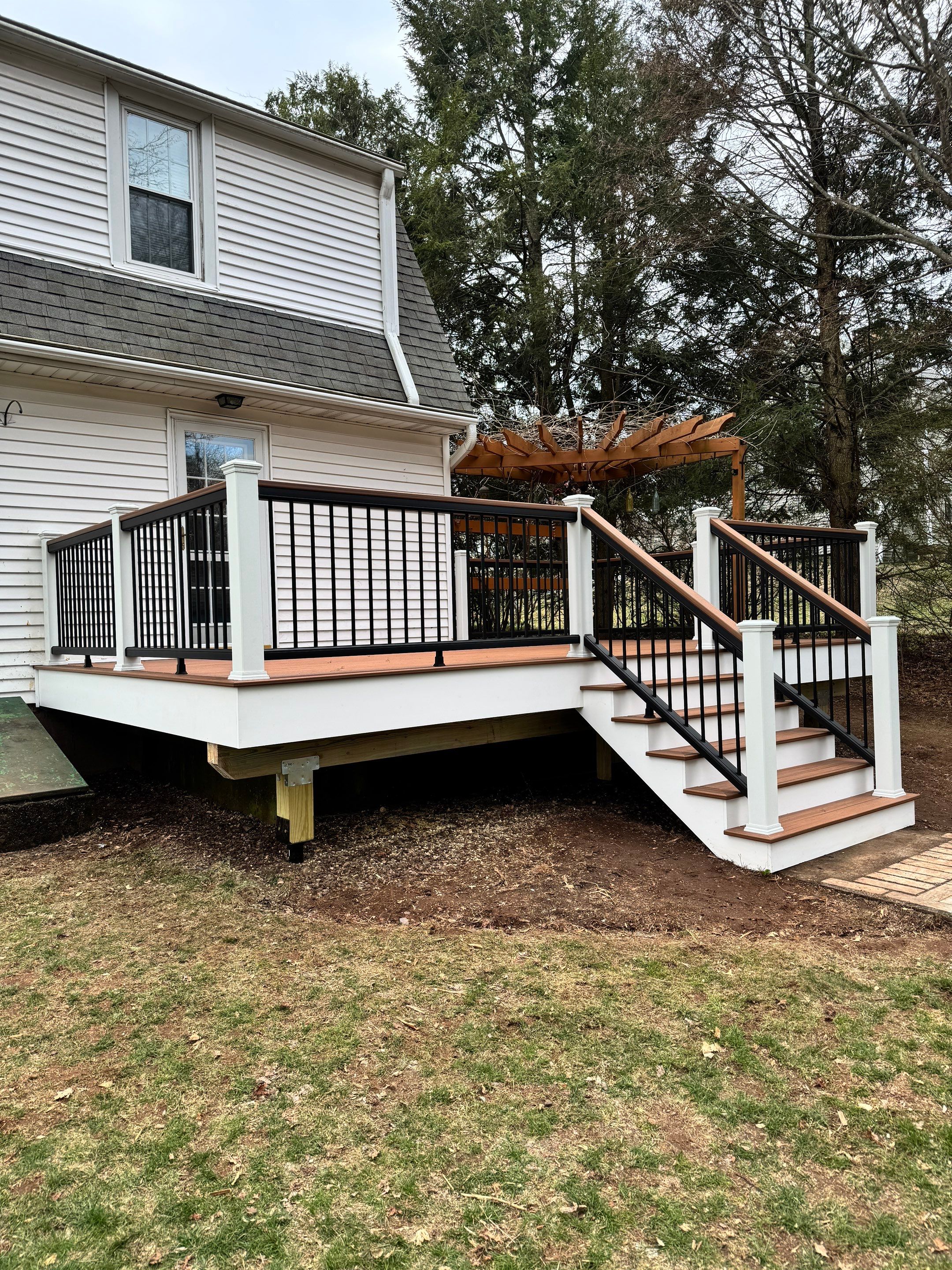 Replacement deck with Trex Transcend Tiki Torch deck boards and matching cocktail rail. by DiGiorgi Roofing and Siding Inc