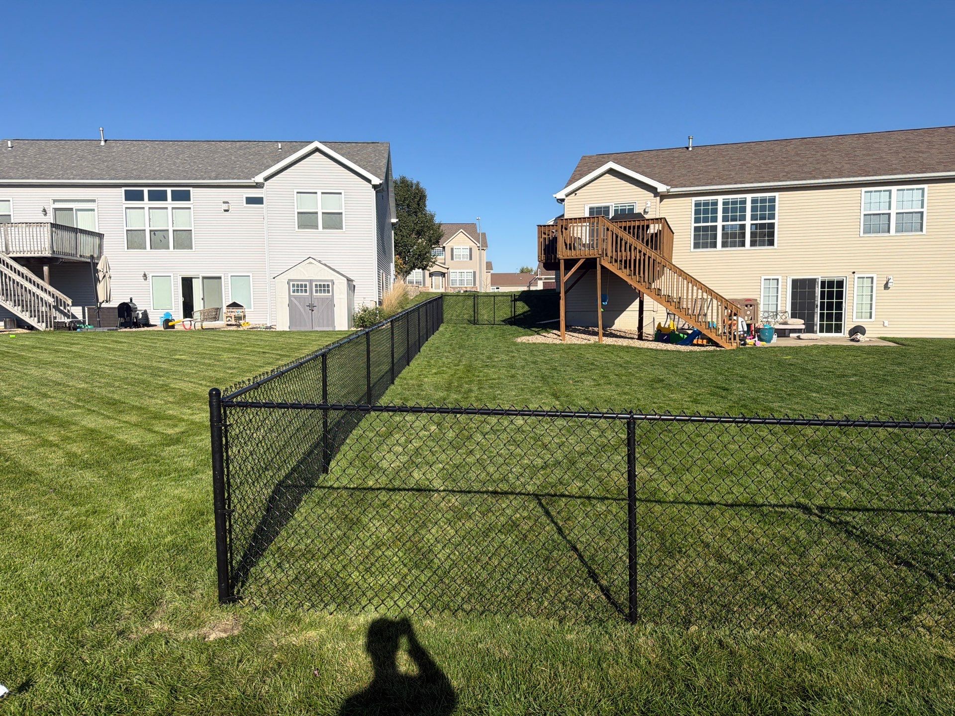 Black Vinyl-Coated Chain Link Fence Installation in Cedar Falls by Perfect Picket Fence and Stain