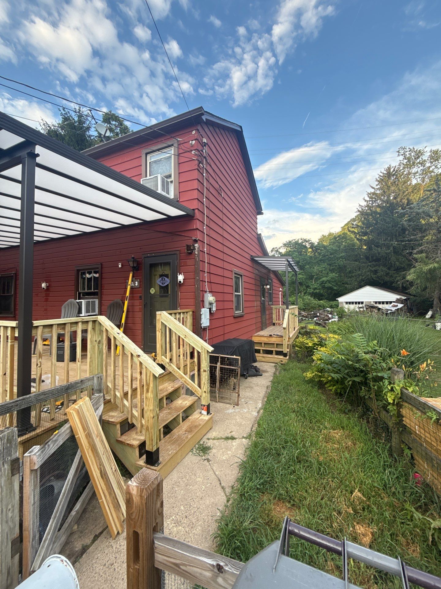 Roof sunspace deck  by Cousins Roofing Siding & Decks