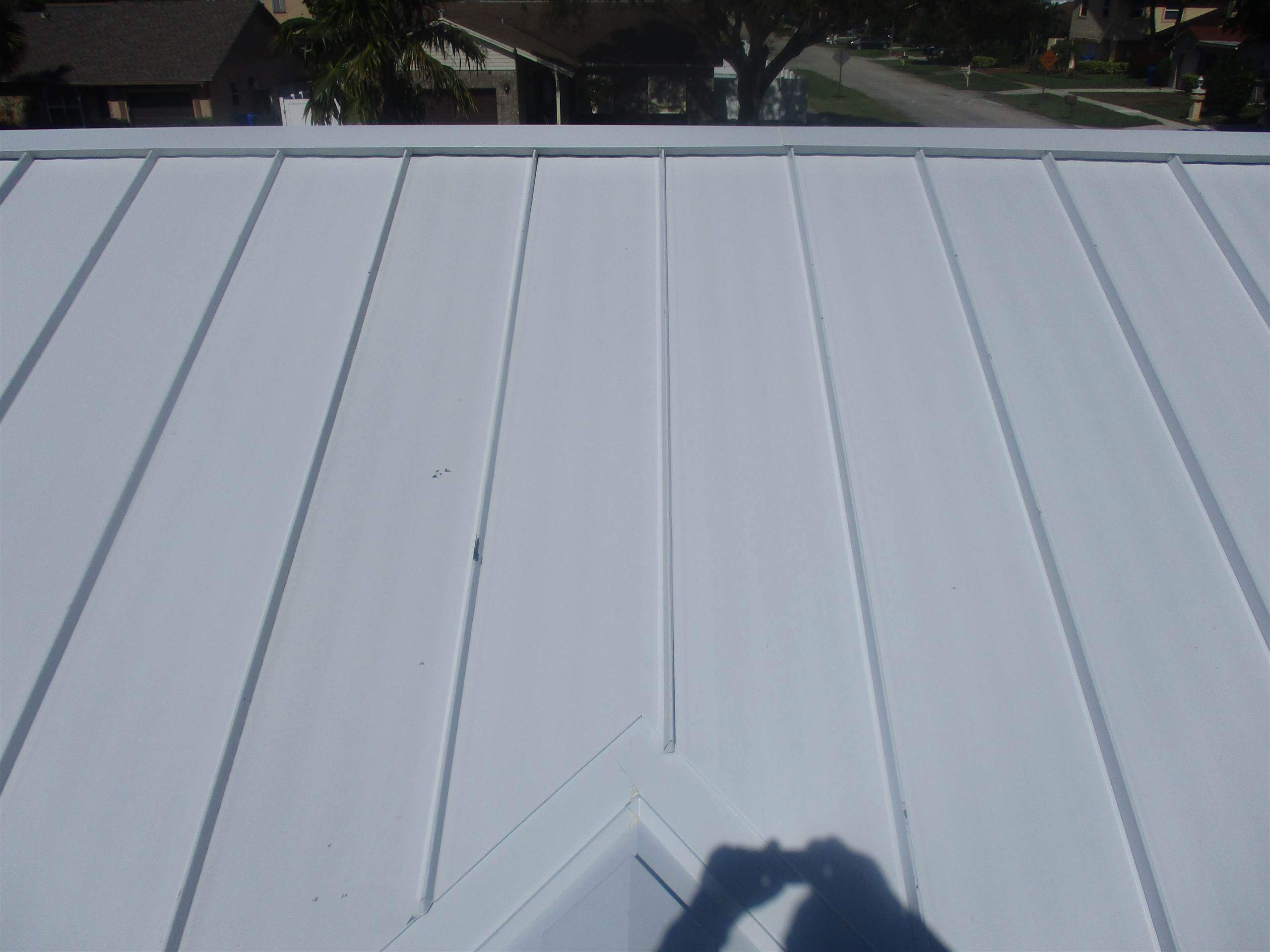 Standing Seam Metal & Flat Re-Roof using 1.5" Nail Strip 24ga Solar White Kynar Coated Standing Seam Metal Panels by Morton Roofing, Inc.