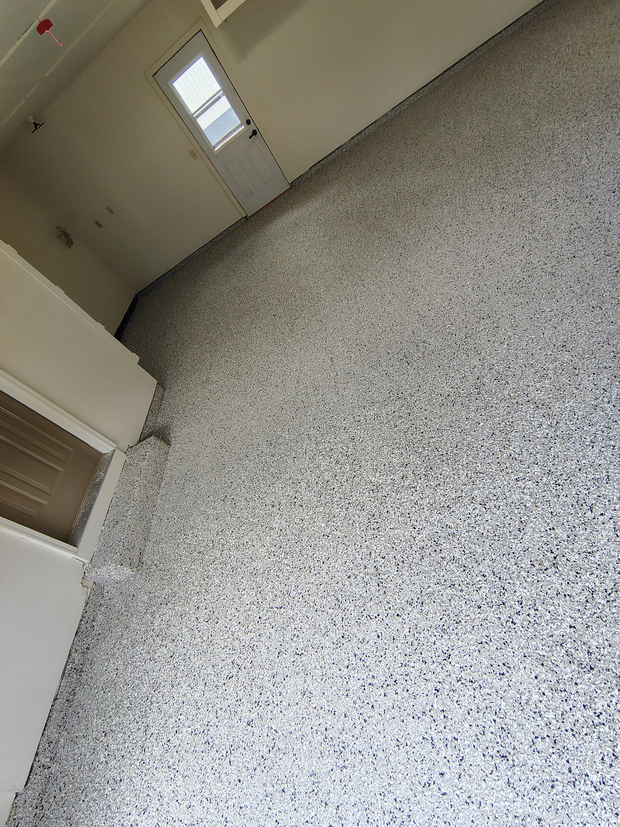 Full-Flake Epoxy Garage Floor Coating Installation in Sioux Falls by Select Painting, Coatings & Garage Cabinets