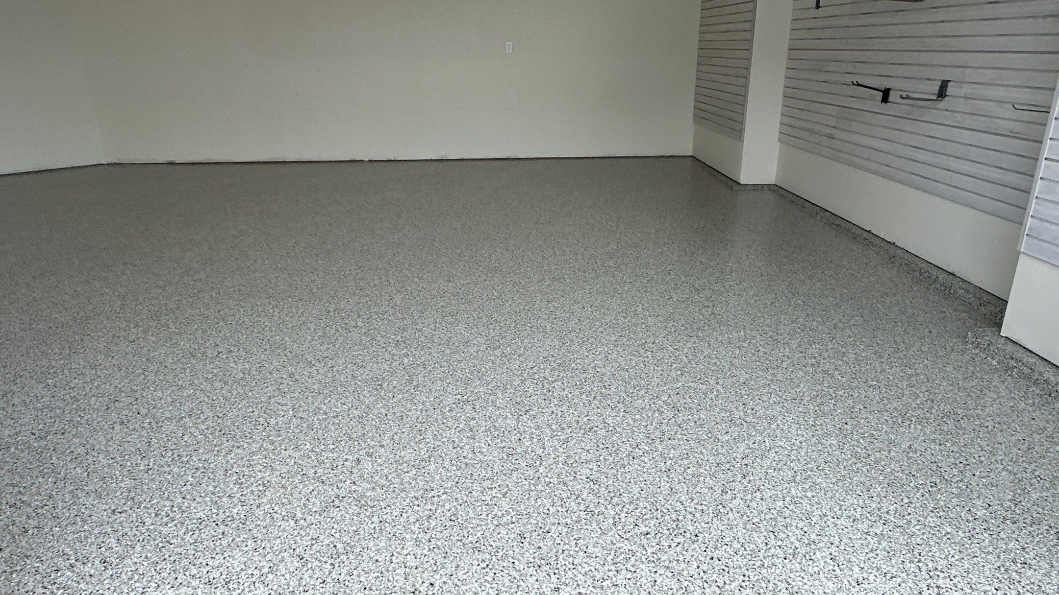 Jon S. transformed his garage with a new floor, slotwall & Cabinets! by Banner Garage