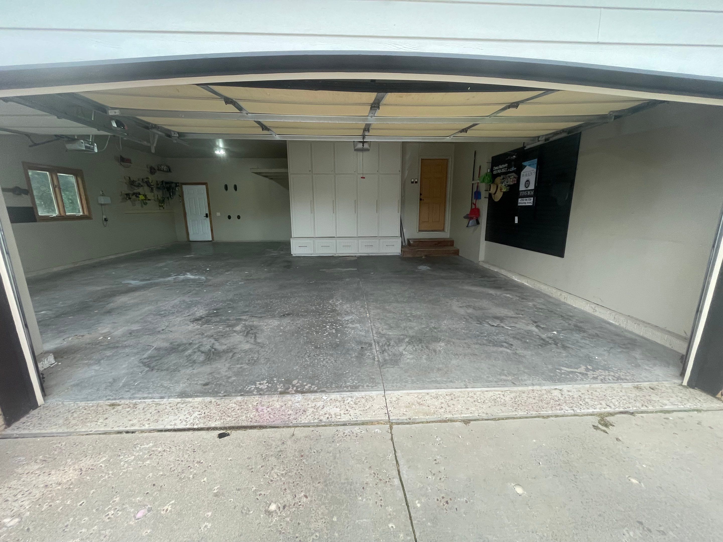 Cabin FEver Flake Garage Floor Coating Installation in Sioux Falls by Select Painting, Coatings & Garage Cabinets
