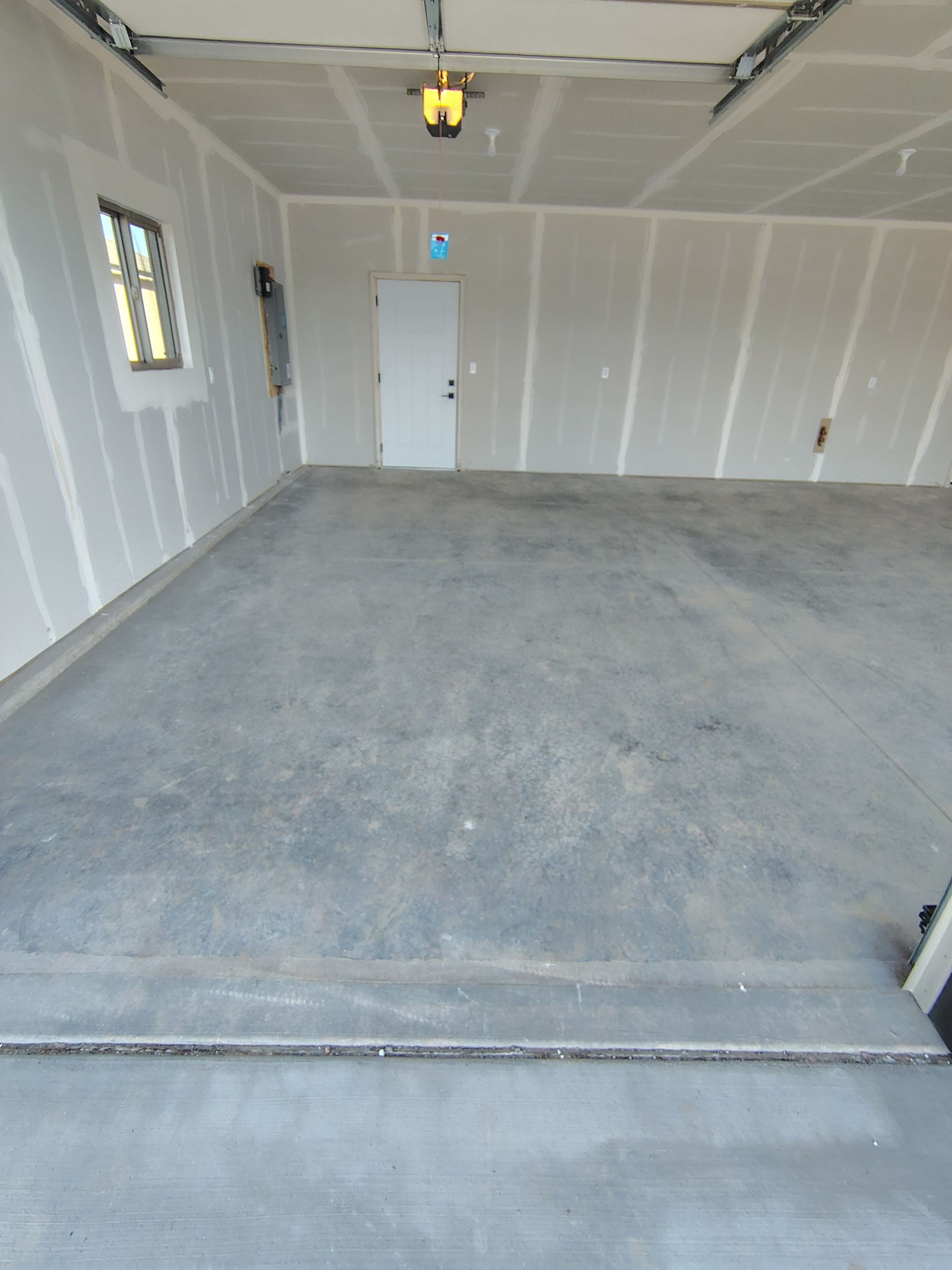 Speckled Epoxy Garage Floor Coating Installation in Sioux Falls by Select Painting, Coatings & Garage Cabinets